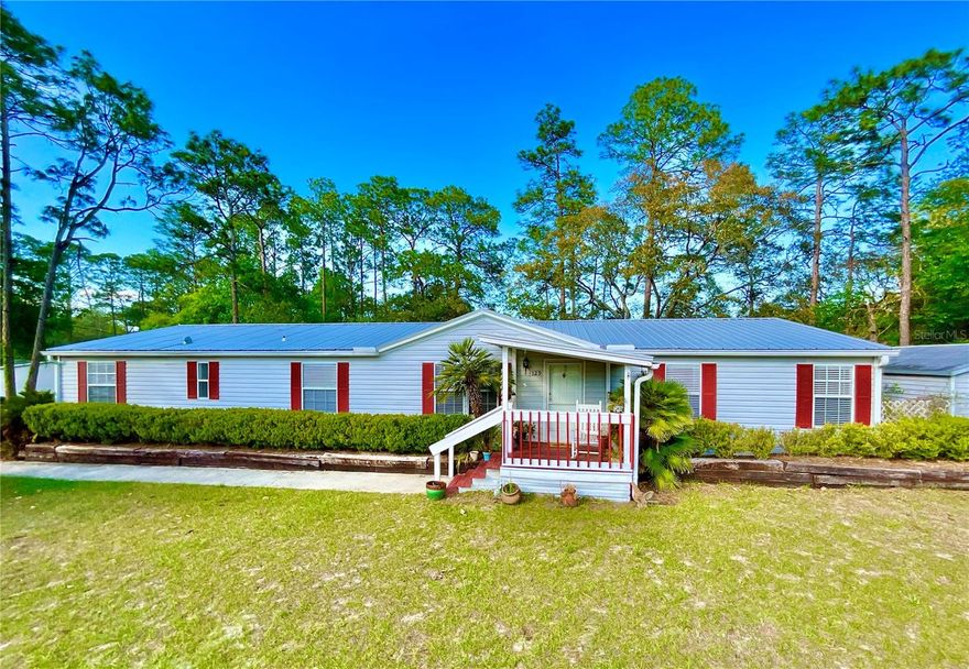 Well-maintained triple-wide mobile home located in Ashley Lake Plantation on 1.02 acres with AG zoning, offering 2,150 square feet of heated and cooled living space. This spacious 4-bedroom, 3-bath home features an open island kitchen with stainless steel appliances, a pantry, and an inside laundry room. A versatile bonus room adjacent to the primary suite is perfect for a home office or flex space. Relax in the family room with a cozy fireplace and enjoy peaceful water views. Roof replaced in 2019. Oversized shed/workshop with ramp access, perfect for storage, hobbies, or workspace needs. Open interior offers flexible use for equipment, tools, or recreational gear. Great functional space with easy access. Conveniently located near historic downtown Melrose and Lake Santa Fe, with an easy commute to Gainesville and Palatka. Schedule your tour today!