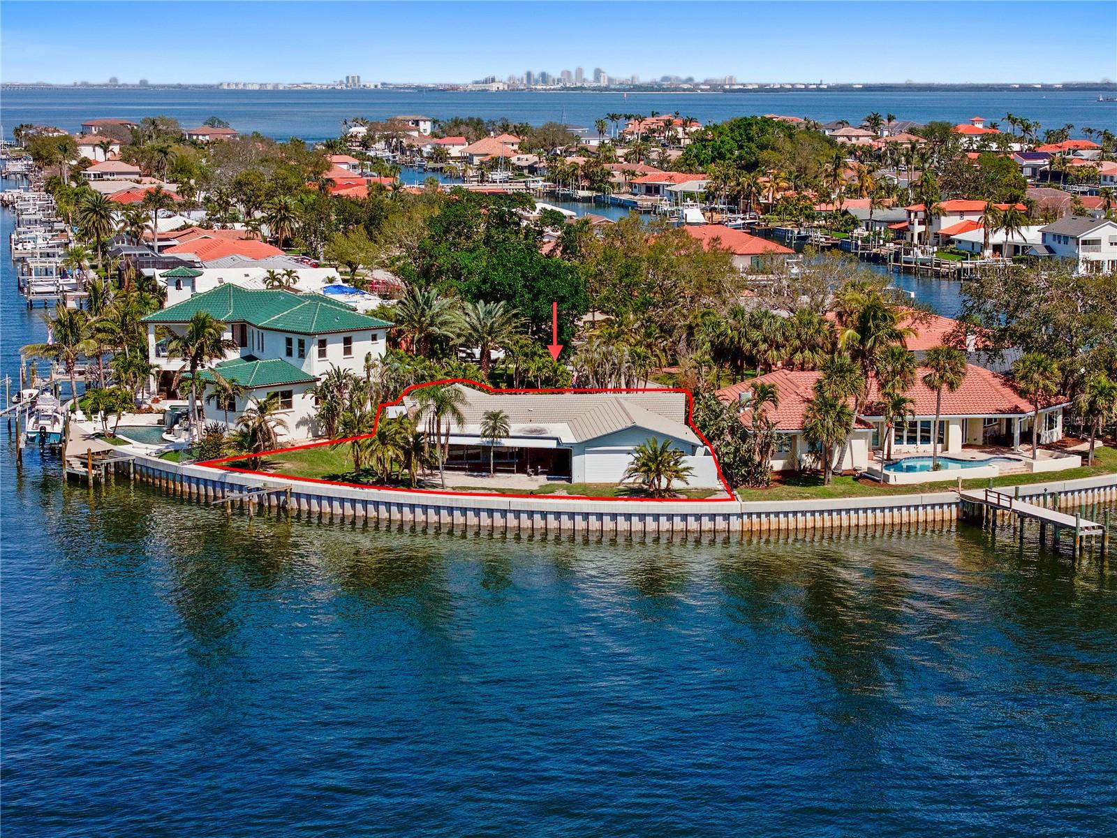 Wake up to breathtaking open water views, where the sun rises over Downtown St. Pete, painting the sky in shades of gold and pink. Watch as dolphins play and manatees glide through the bay, creating a peaceful start to your day. In the evening, the twinkling city skyline and the vibrant lights of the Sunshine Skyway Bridge create a serene and relaxing backdrop. This prime Venetian Isles property presents an incredible opportunity to build your dream home on a spectacular waterfront lot. While the existing home was affected by flooding, damaged materials have been removed, leaving a blank canvas for your vision. A brand-new seawall (2023) and new impact-rated windows and sliding doors provide a strong foundation for the future. Nestled at the end of a peaceful cul-de-sac, this property offers a rare chance to create a custom-designed estate in one of St. Pete’s most sought-after waterfront communities. Whether you choose to renovate or start fresh, this lot delivers unmatched potential and panoramic views in a location that is second to none. With direct access to Tampa Bay and the Gulf of Mexico, this property is a boater’s paradise—bring your boat and set sail within minutes. Located just minutes from downtown St. Petersburg’s vibrant dining, shopping, and cultural attractions, Venetian Isles combines tranquil waterfront living with urban accessibility. You can bike, take your golf cart, or even your boat in minutes to enjoy all Downtown has to offer. Quick access to the interstate, Tampa International Airport, and our World famous white sand beaches makes it a one-of-a-kind location. Experience the pinnacle of luxury, comfort, and convenience. Don’t miss this rare opportunity to bring your dream home to life in desirable Venetian Isles!