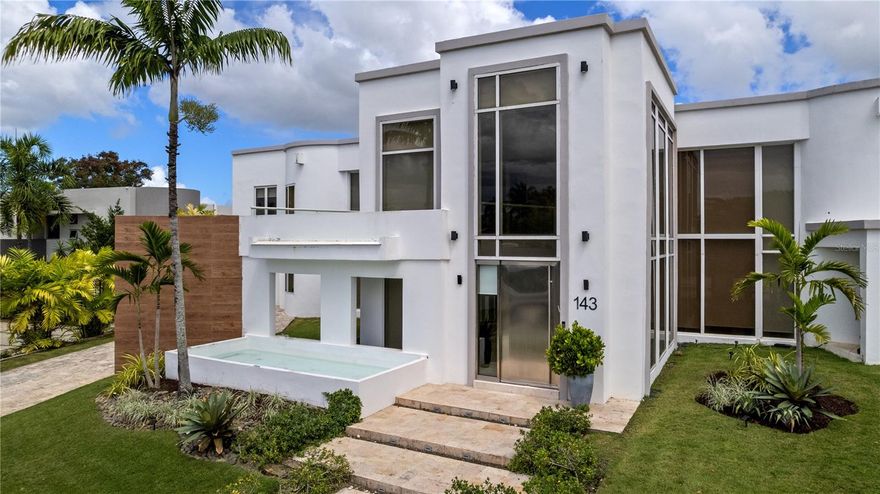 Exquisite Estate Residence at "La Villa de Torrimar" Community in Guaynabo. This contemporary residence, currently unfurnished, with two level offers a turnkey opportunity with 5 bedrooms and 5 full bathrooms, plus 2 half bathrooms. The Living and dining areas overlook to the pool, and the outdoor gazebo with BBQ/ within its residential amenities a practice soccer field, practice basketball court, green areas, spacious garage for two. Open Space Concept with a fully equipped kitchen with stainless steel appliances, playroom and office area too. On the second level bedrooms enjoy of a family room with balcony and the 4 bedrooms with their own bathrooms, located in this level, have direct access to outdoor terrace. Full Generator, 2 solar water heaters, security cameras, security windows and doors. "La Villa de Torrimar" is a gated community with 24/7 guards, offers tennis courts, pickleball courts, playgrounds, basketball courts, activity rooms and gym.