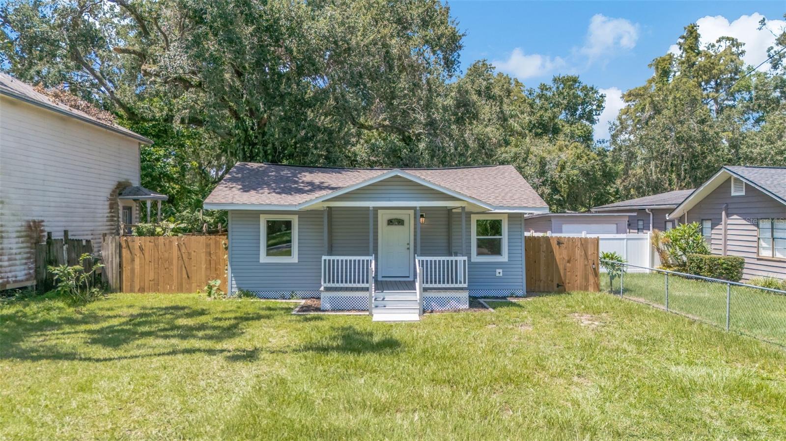Welcome to this tastefully renovated gem in the heart of Tampa! Practically everything has been updated, ensuring peace of mind from day one. This three-bedroom, two-bathroom home was taken down to the studs and rebuilt to strict hurricane codes. It features a full metal hurricane strapping system from ground to roof, double-stud new exterior walls, hurricane impact windows, new siding, porch, roof (2022), and spray foam insulation for comfort and efficiency. Updated electrical and plumbing are the cherry on top! Enjoy an inviting open layout that connects the living, dining, and kitchen areas, perfect for gatherings with friends and family. The sleek kitchen features stainless steel appliances and stone countertops. The primary bedroom offers an ensuite bathroom and walk-in closet along with private access to the back yard and deck. Upon stepping outside, you’re greeted with a fully fenced and spacious yard that includes a separate shed for storage and laundry use. The two additional bedrooms include built-in closets and ceiling fans ensuring maximum comfort and close proximity to the second bathroom located in the hallway. Centrally located and just a short drive to Bush Gardens, Downtown Tampa, and Tampa International Airport this home offers the perfect blend of convenience and tranquility. Furthermore, this home is NOT located in a flood zone. Act quickly and make this one yours today!