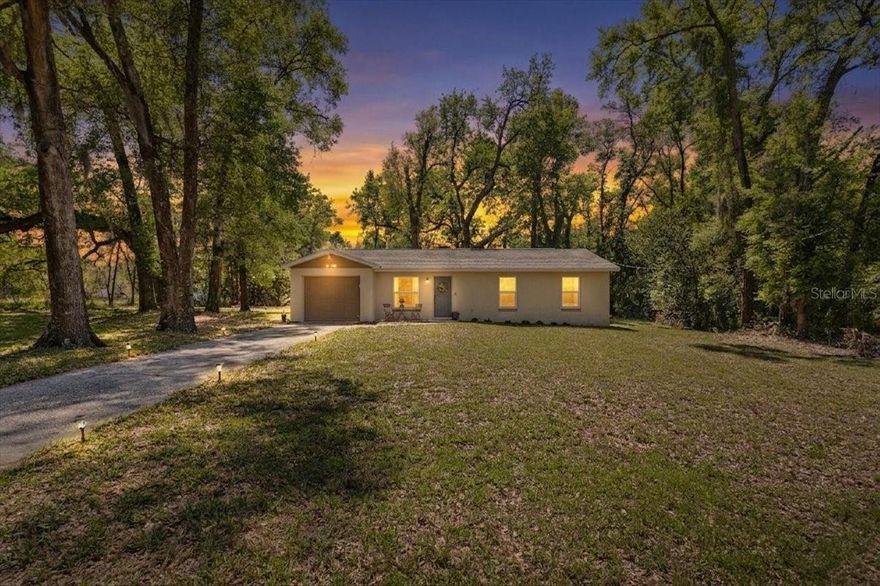 Welcome to your fully reimagined Florida retreat—where modern upgrades meet peaceful, country-style living just minutes from everything. Situated on an oversized 0.38-acre lot in the heart of Wildwood, this completely renovated 3-bedroom, 2-bath home with a one-car garage (2024–2025) offers the rare combination of no HOA, no flood zone, and true move-in-ready peace of mind. From the moment you arrive, you’ll notice the privacy—no front neighbors, a quiet paved road, and mature oak trees creating a serene, tucked-away setting. With ample space to park your RV, boat, or even design your dream pool, this property gives you the flexibility most homes simply can’t. Inside, nothing was compromised—every detail has been thoughtfully upgraded for both style and longevity. Enjoy impact-rated, double-insulated windows, new impact rated exterior doors & garage door, and a brand-new roof on both the home and shed—all designed to maximize durability and deliver significant insurance savings. The interior features waterproof luxury vinyl flooring throughout (no carpet anywhere), beautifully textured walls, new light fixtures, six-panel doors, updated electrical and plumbing systems. The kitchen is both stylish and functional, featuring granite countertops, Shaker Wood Cabinets, brand-new Whirlpool Stainless Steel appliances, and seamless flow into the living and dining areas—perfect for everyday living or entertaining. A whole-house water filtration system and new 2024 water heater add even more value and convenience. The primary suite offers a private half bath and a spacious walk-in closet with custom shelving, while the secondary bedrooms feature double-door closets with built-in organization systems. The main bathroom is finished with tile, tub/shower combination and both bathrooms include updated vanities and quality finishes. Storage is abundant throughout the home, including a generous linen closet in the hallway and a coat closet at the front entry, plus attic plywood decking for even more storage space. Additional highlights include a security camera system, a storage shed, and north-facing orientation for balanced natural light throughout the day. Location is where this home truly shines—just minutes from I-75 and the Turnpike, offering easy access while still enjoying the charm of open pastures and quiet countryside as you arrive home. You’re also close to Brownwood Paddock Square, known for its waterfront charm, live music, restaurants, and weekend markets, as well as outdoor recreation at Lake Okahumpka Park and nearby boat access at Coleman Landing Boat Ramp. Wildwood is known as the “Crossroads of Florida,” blending rich history with growth as part of the southern expansion of The Villages—one of the nation’s fastest-growing areas. Enjoy championship golf courses, community park and the perfect balance of rural beauty and modern convenience. If you’ve been searching for a home that offers space, privacy, top-to-bottom upgrades, and unbeatable location—this is the one. A Rated Schools & USDA eligible.