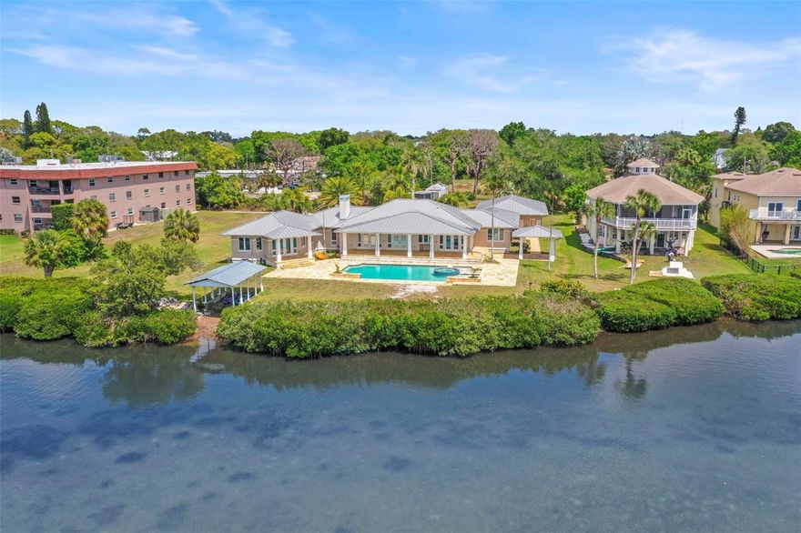 One or more photo(s) has been virtually staged. Tarpon Springs Coastal Estate 

Tucked away on nearly 2.5 private acres near Sunset Beach, this rare waterfront estate captures the essence of  Florida living — private, expansive, and built for a true coastal lifestyle. With approximately 150 feet of  Gulf waterfront, this is the kind of property that’s becoming increasingly hard to find in Pinellas County.

Launch kayaks right from your backyard from your covered boathouse, explore winding coastal waterways, or bring in a flats boat on high tide. Just minutes away, the Sunset Beach boat ramp offers effortless access to the Gulf, creating the perfect setting for boating, fishing, and everyday waterfront living.

Inside, the home spans a spacious layout with soaring vaulted ceilings and natural light pouring in through skylights, creating an open, airy feel throughout. The main living areas are designed for both comfort and entertaining, anchored by a large family room that flows seamlessly to a covered back porch overlooking the pool and stretching out toward Gulf-facing views — where evenings are best spent entertaining as the sun sets and dolphins play just beyond your backyard.

The residence features 5 bedrooms and 4 bathrooms, including two primary suites, each complete with walk-in closets and private en-suite bathrooms — ideal for multi-generational living, hosting guests, or creating a true owner’s retreat. Additional bedrooms are generously sized, offering comfort and flexibility for family and visitors alike.

A dedicated office/flex space provides the perfect setup for working from home, a gym, or creative studio, while a large laundry room adds everyday convenience.

The kitchen is ready to be transformed into a true showpiece — envision a beautifully designed chef’s space overlooking tranquil water views, complete with a dedicated gas range, double ovens, and an expansive layout built for gathering and entertaining.

Major improvements have already been completed, including all new HVAC systems in 2025, updated LED lighting throughout, new drywall, and fresh interior and exterior paint — offering a clean, solid, and well-maintained canvas ready for your vision and personal touch. A metal roof, resort-style pool, and detached 3-car garage add both durability and versatility to the property.

Designed by locally recognized Hoffman Architects in 2007, the home carries strong architectural bones and character, making it an ideal foundation for a custom luxury transformation.

Located in a golf cart–friendly community, you’re just a short ride to downtown Tarpon Springs, where local shops, restaurants, bars, and the world-famous Tarpon Springs Sponge Docks create a vibrant coastal lifestyle unlike anywhere else.

Properties like this don’t come around often — private acreage, waterfront access, and unlimited potential all in one of the Gulf Coast’s most unique coastal settings.

***Zoned RM – Residential Multi-Family District. RM zoning in Tarpon Springs, FL, stands for Residential Multifamily District, designed to provide for multi-family dwellings at varying densities.. RM zones (often categorized as Medium-Density RM) may allow for density increases up to 15 dwelling units an acre. - To BE VERIFIED BY SELLER & SELLERS AGENT.***