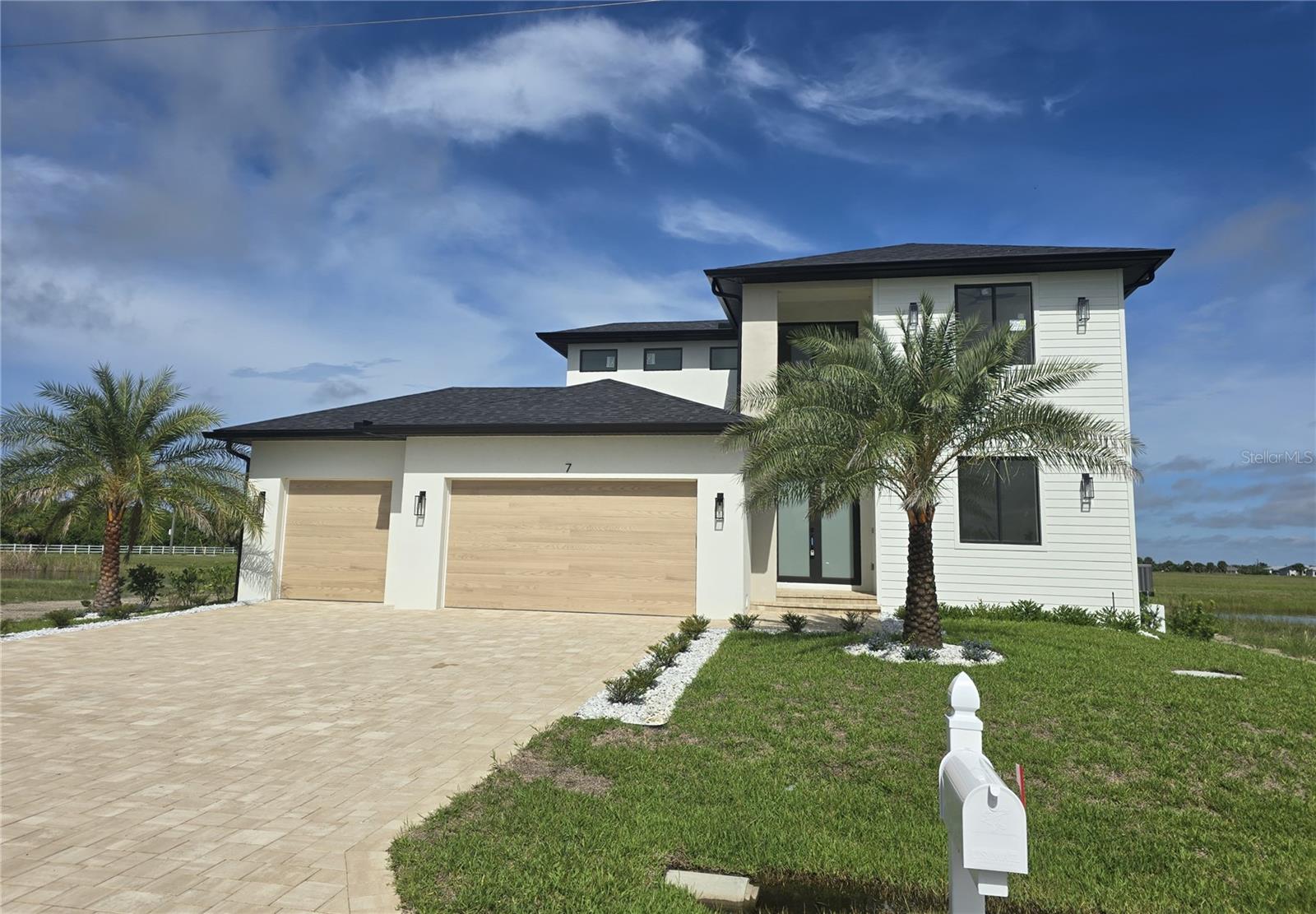 Under Construction. Discover this stunning two-story residence that perfectly combines sophisticated design with tranquil waterview living. Boasting 3 spacious bedrooms, a versatile den, and 2½ bathrooms, this home offers an exceptional blend of comfort and style. The highlight of the culinary space is a breathtaking quartz waterfall kitchen island, ideal for entertaining guests or enjoying family meals. Wake up to serene water views every morning and unwind in a quiet, peaceful setting. The interior features a beautifully illuminated stairway that adds a touch of elegance, while the outdoor kitchen invites you to host unforgettable gatherings in a tranquil environment. Experience the harmony of modern amenities and natural beauty in this exceptional property. First floor features the primary bedroom and den along with the kitchen. Second floor retreat has 2 guest bedrooms an offers extra privacy and comfort with waterviews from upstairs! This stunning home features impact windows for that extra piece of mind! Schedule your showing to view this rare opportunity to be a part of Rotonda Meadows!