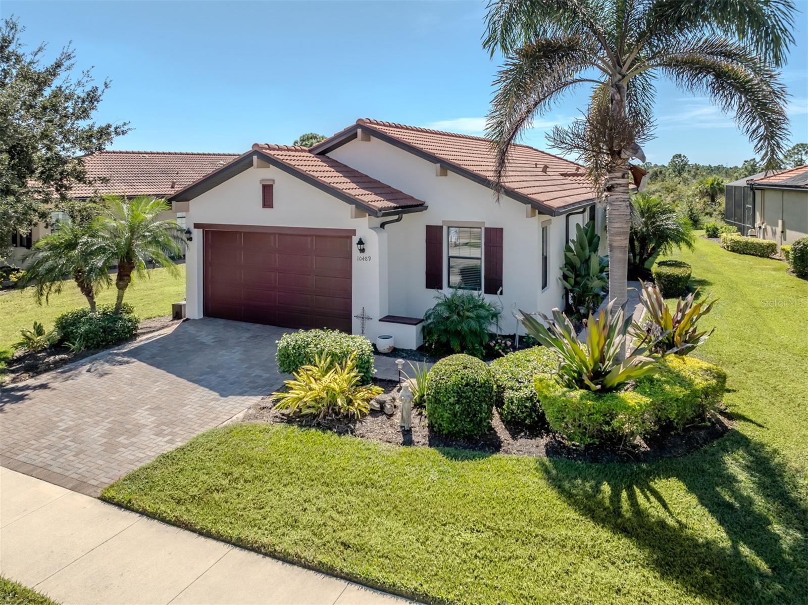 This meticulously maintained, WCI-built residence nestled in the highly sought after, resort-style community of Sarasota National Golf Club. This beautifully appointed 2-bedroom, den, 2-bath home, with 2 car garage offers just under 1,600 sq. ft. of stylish and functional living space with 9’10" ceilings throughout with upscale finishes. This home is perfectly situated on a serene preserve view lot with plenty of privacy. Upgrades include 2024 and 2025 new appliances, 2023 new Pergo water resistant flooring in bedrooms, 2022 newly installed French doors to den, 2021 AC compressor and capacitor, 2020 interior re-painted, 2019 whole house surge protector, new hot water heater, and exterior paint, FULL HURRICANE PROTECTION, and much more! Step inside to discover an open and airy floor plan featuring 18-inch ceramic tile on the diagonal throughout the main living areas and new Pergo flooring in the bedrooms. The kitchen is a chef’s delight, boasting solid wood cabinetry with soft close drawers with several pullout shelving drawers, granite countertops, stainless steel appliances, and a tiled backsplash, all complemented by recessed lighting and elegant crown molding. The spacious primary suite is privately located at the back of the home and filled with natural light from large windows. Features include a tray ceiling, a luxurious ensuite bath with glass-enclosed shower, dual sinks, quartz countertops, and a large walk-in closet. The second bedroom is thoughtfully placed at the front of the home, adjacent to the second full bath, perfect for guests. The den is positioned in the heart of the home with glass doors and provides the perfect space for a home office, media room, or guest room overflow. A separate inside utility room includes a sink and cabinetry for added storage and convenience. Enjoy peaceful mornings or relaxing evenings on the screened lanai overlooking the lush, private preserve setting. Additional features include window treatments, a paver driveway and walkway, and a spacious 2-car garage. Live every day like you are on vacation in this resort-style community. This community boasts a 30,000 sq. ft. clubhouse with resort-style pool, outdoor tiki, a coffee room, Palm Club restaurant, 7,000 sq. ft. fitness center, fitness classes, day spa, card room, bocce ball, pickleball, tennis, dog park, playground and event lawn. Sarasota National has also been certified by the International Audubon Society. Near the new Atlanta Braves spring training ballpark, newly built downtown Wellen Park, pristine beaches, newly built Costco, shopping, dining, medical facilities, U.S. 41 and Interstate 75. GOLF IS NOT REQUIRED WITH THIS HOME and NO restaurant minimums!
