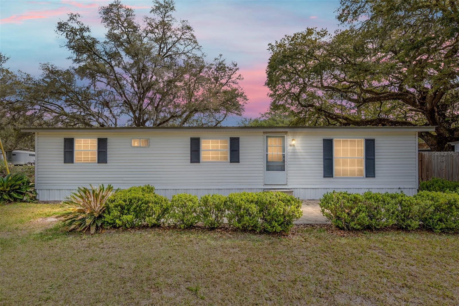 Well maintained 3 bedroom, 2 bath home on almost an acre! Mobile has been updated and is move in ready! Super location near the river, boat ramp, and the Ocala National Forest. Lots of new building in the area. You will appreciate the convenience of location, yet still enjoy a beautiful country-like, community setting. Pride of ownership shows on every corner. The home is cute and comfortable. Enjoy relaxing on your screened porch, or out in the yard. It is the perfect winter retreat, rental, or enjoy the peaceful country atmosphere full time. Great location on an oversized corner lot with paved road frontage. Several outbuildings for storage and parking, as well as an RV pad and hookup. Too many features to list on this unique property! Some furnishings may be available. Make your appointment today before its gone!
