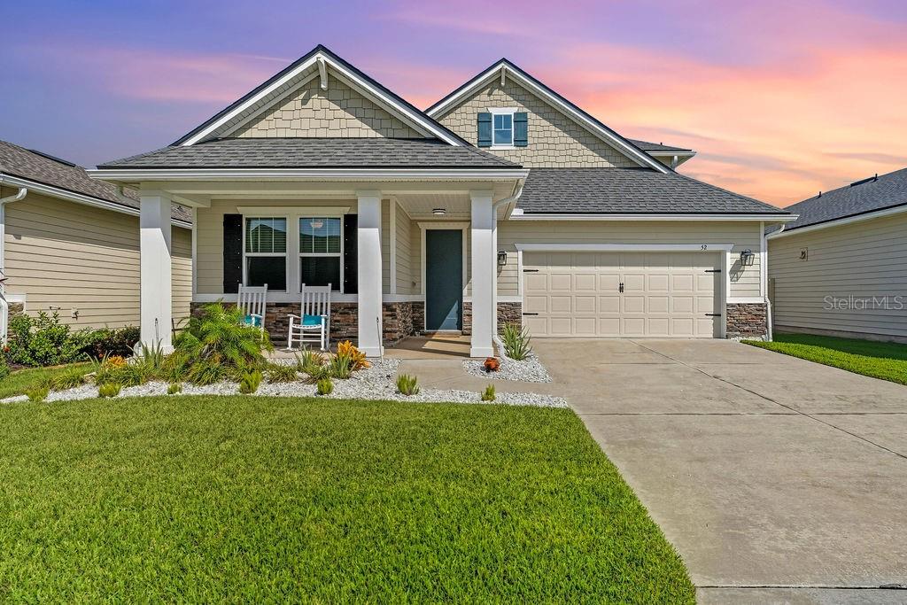 WELCOME HOME TO 52 LOS LAGOS BLVD! Nestled in the desirable Los Lagos community at Matanzas Shores, this STUNNING coastal-style PRIVATE POOL home offers the perfect blend of luxury, comfort, and an ACTIVE beachside lifestyle. Built in 2021, this casually elegant 4-bedroom 3-bathroom home is designed with timeless class and modern amenities, making it the ideal retreat for those who appreciate the finer things in life. Boasting an expansive layout and 3-way split floorplan, the primary suite is conveniently located on the first floor, while a spacious LOFT upstairs (along with bedroom #4 and full bath) offers endless possibilities for relaxation or entertainment. Two secondary bedrooms along with a guest bath are conveniently located in the front of the home. The home features a chef’s kitchen with stainless steel appliances, sleek quartz countertops, subway tile backsplash, a large center island, gorgeous hardware finishes and pendant lighting, abundant cabinetry storage with pull-outs and a generously sized pantry – perfect for preparing gourmet meals or spreading out TAILGATE treats for FOOTBALL SEASON! The open-concept living/dining combo GREAT ROOM flows seamlessly onto the covered lanai offering an outdoor POOLSIDE living room, making this home an entertainer’s dream! Custom retractable Maestro Screens and Suntec Shades can enclose the lanai for extra privacy or keep them open to access the Travertine Tile Pool Deck and HEATED SALTWATER POOL complete with a LARGE SUN SHELF, Bubbler and LED-LIGHTS. Additional highlights and upgrades include vinyl privacy fencing surrounding the backyard, french drain system tied into pool drain, luxury wood plank-style tile throughout the downstairs of the home except for the carpeted bedrooms. The SPACIOUS Primary Suite overlooks the backyard and pool area and offers privacy and luxury including dual closets and dual sinks, large walk-in shower and water closet. The tropical landscaping adds an extra touch of beauty to this already impressive property. The community’s incredible amenities include underground utilities, an oceanfront clubhouse with a pool, a large day dock with fishing stations on the Intracoastal Waterway as well as a kayak launch, tennis and pickleball courts, shuffleboard, bocce ball, and direct beach access. LOS LAGOS at MATANZAS SHORES is conveniently located along scenic A1A, giving you easy access to historic St. Augustine, Marineland, Flagler Beach, and local restaurants, grocery stores, parks and the boat launch at Bings Landing. This home truly feels like living on vacation year-round. Don’t miss the opportunity to own your slice of paradise! ** Some furnishings and decor may be negotiated outside of the contract. WHAT ARE YOU WAITING FOR? Your time is NOW!!