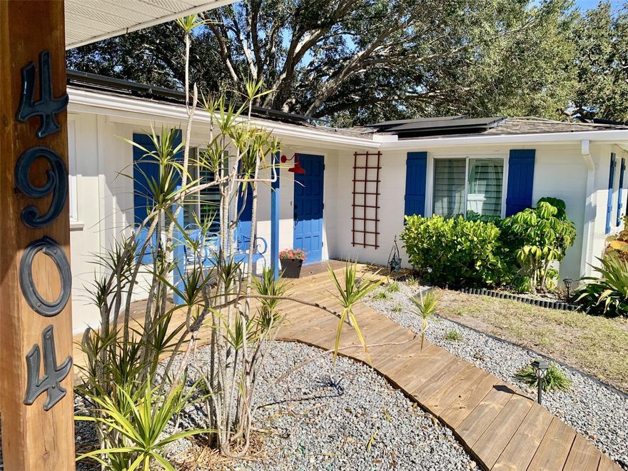 Move in ready midcentury charmer on a spacious ¼-acre corner lot is just minutes from the Gulf beaches! This adorable 2 bed, 1 bath home with a 1 car carport has been beautifully updated with fresh coastal colors and offers classic Florida style with modern upgrades throughout.
Beautiful laminate flooring, indoor laundry, and a fully renovated bathroom featuring a large frameless glass walk-in shower. The kitchen is well appointed with stainless steel appliances, including a new stove with a built in air fryer. French doors from the living room open to a large screened lanai, perfect for relaxing or entertaining. A storage shed out back, provides added storage. Major updates include a 2010 roof, new solar roof system, 2025 HVAC, and 2016 water heater. Additionally, nearly all the window have been updated to the high demand and very expensive, hurricane rated, super efficient, impact glass. All have the very popular plantation shutters. Couple these with the efficient roof solar system and you have a self sustaining eco system. Your new home is NOT located in a flood zone and flood insurance is NOT required!! Home could easily be converted to a 3/2 split by converting the carport into a bedroom and the laundry area into a bathroom giving you 1500+sf of living. Location, location, location. Your new home is one block east of the multi million dollar GT Bray 140 acre, recreational hub. See virtual tour Link 2 for details of this world class park, steps from your door. Olympic sized pool, fitness center, skate park, dog park, athletic fields, pickleball, racquetball, basketball, baseball, splash pad, nature walking paths and so much more. Also IMG Academy sports is just to the south. And for you golfers, the members only Bradenton Country Club, a Donald Ross designed 18 hole golf course is just a half mile north. Your new home is located just south of Tampa Bay, close to shopping, restaurants, museums, hospitals, and only minutes to Anna Maria Island, known for its virgin beaches with pristine sugar sand, clear aqua waters and gentle soul refreshing waves. This home is perfect as a starter home, retirement residence, winter getaway, or investment property. The location allows for unrestricted short term, seasonal or long term rentals, therefore offering excellent income potential, between your visits. Mirror in bathroom and bench seat in dining room do not convey. All measurements are approximate and not guaranteed. Call today!!