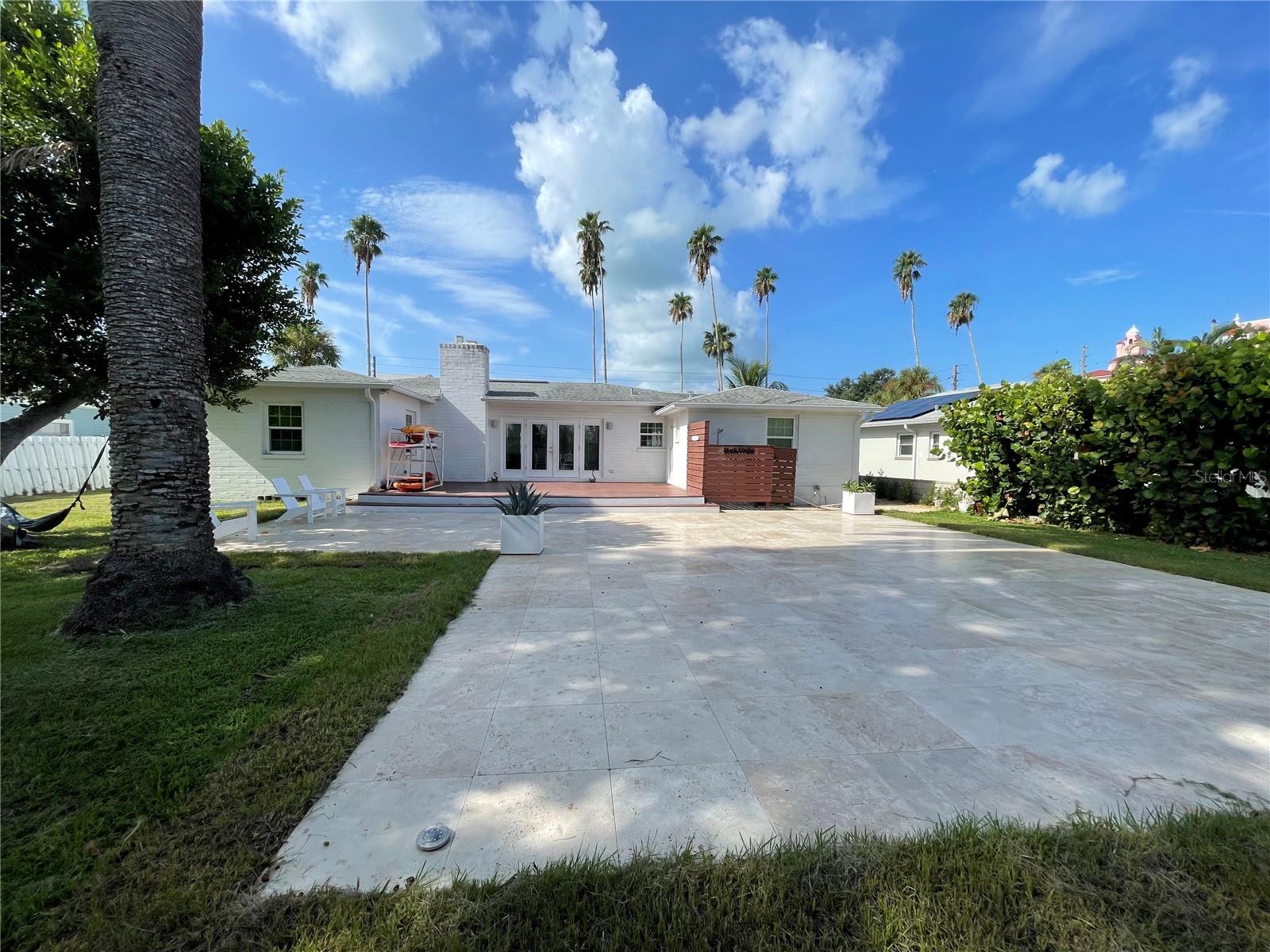 LOCATION - LOCATION - LOCATION - Built in 1939, completely renovated in June 2023. Gorgeous two-bedroom, two-bathroom house nestled in the exclusive area of the historic Don Cesar Hotel. Contemporary interior style, keeping the charm of an original St. Pete Beach landmark house. The home features 1427 sq. ft of fully renovated living space and amazing brand-new bathrooms. It is listed with two bedrooms, but there is an additional small room with no closet. The house is partially finished, and you can have your own—a vast travertine backyard to enjoy the fantastic Florida weather. Magnificent front and back views of the famous Don Cesar. Steps away from the sandy beaches through private access, a public boat ramp, and the fantastic Lazarillo Park with a Playground and tennis courts. Florida at its best!