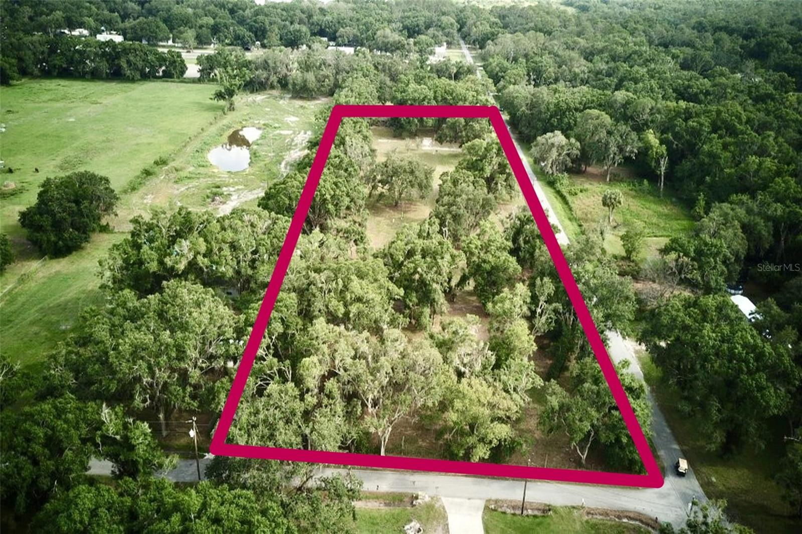 This mostly cleared 3.3+ acre vacant lot offers a rare combination of space, privacy, and existing infrastructure, making it ready for your vision—whether that’s a custom home, multi-unit development, or private retreat. This property was originally 3 separate lots (each about 1.10 acres in size for a total of 3.3 MOL) with 3 homes, with 2 of the lots sharing a well. The owners prefer to only sell as one complete lot. The property features three wells, two septic systems, and two separate driveways, providing flexibility for multiple structures or access points. Utilities are already in place with cable connected and fiber internet available, ensuring modern connectivity from day one. The land is mostly fenced, with only the driveway entrances open, offering a balance of security and accessibility. With its unique setup and versatile potential, this property is a prime opportunity for those looking to build without starting from scratch.