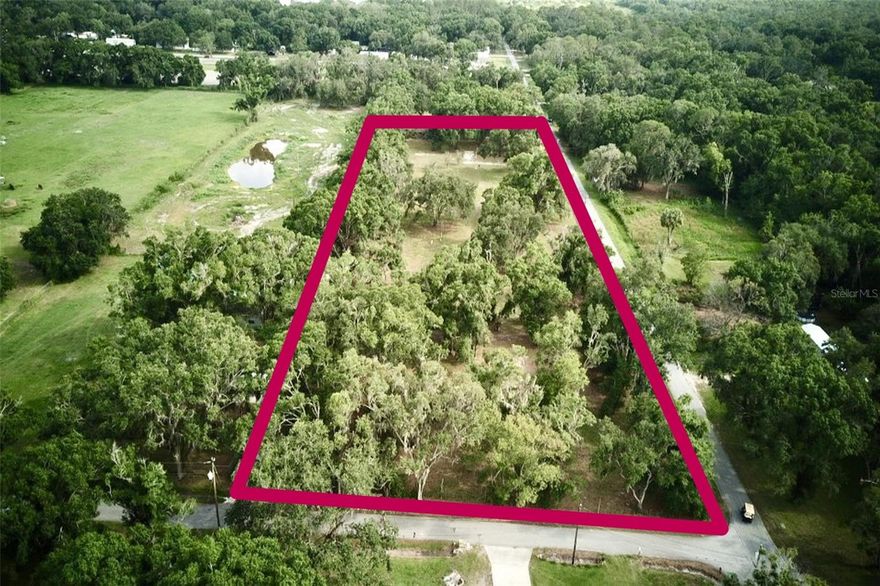 This mostly cleared 3.3+ acre vacant lot offers a rare combination of space, privacy, and existing infrastructure, making it ready for your vision—whether that’s a custom home, multi-unit development, or private retreat. This property was originally 3 separate lots (each about 1.10 acres in size for a total of 3.3 MOL) with 3 homes, with 2 of the lots sharing a well. The owners prefer to only sell as one complete lot. The property features three wells, two septic systems, and two separate driveways, providing flexibility for multiple structures or access points. Utilities are already in place with cable connected and fiber internet available, ensuring modern connectivity from day one. The land is mostly fenced, with only the driveway entrances open, offering a balance of security and accessibility. With its unique setup and versatile potential, this property is a prime opportunity for those looking to build without starting from scratch.
