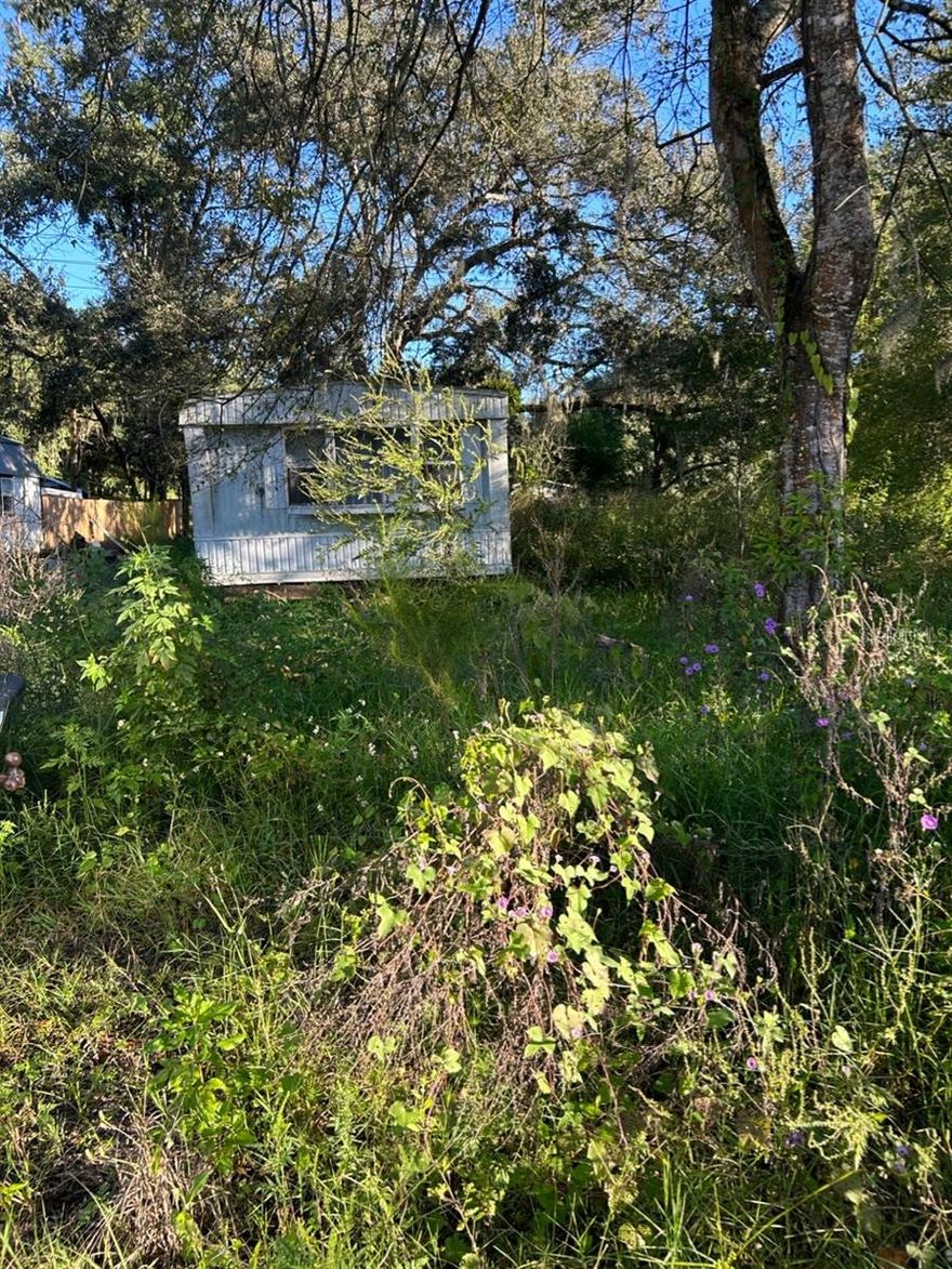 2/2 mobile home with lots of potential on 0.15/acre. Public water hookup available and septic tank on property in unknown condition. Not currently hooked to any utilities. Situated down secluded dirt roads, with two entrances to the property. Outside of Zephyrhills city limits, but just a mile to downtown and many new subdivisions.