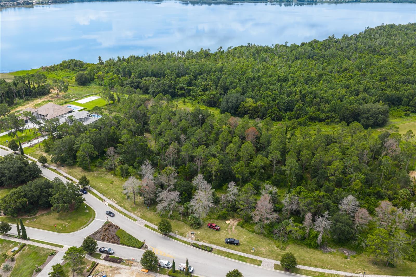 Expansive 1.27-acre wooded lot, this homesite is the perfect canvas for your custom dream home. Choose from seven fully custom builders with no required timeline to start construction, giving you the flexibility to design your forever home in the premier gated golf community of Bella Collina. Renowned for its breathtaking scenery and impeccably maintained landscaping, Bella Collina offers an unmatched lifestyle.
Conveniently located just 1.5 miles from Montverde Academy and with easy access to the Florida Turnpike, Hwy 408, and 429, the property is also minutes from downtown Winter Garden’s charming shops and Saturday farmers market.
As a resident, you’ll enjoy exclusive access to The Club at Bella Collina, featuring year-round social and culinary events, an 18-hole Championship golf course designed by Nick Faldo, Har-Tru tennis courts, pickleball courts, a resort-style pool complex, a state-of-the-art fitness center with complimentary classes, a luxurious spa, and multiple dining options.
This exceptional homesite includes the $40,000 Sports Membership Deposit from the Seller making it even easier to embrace the extraordinary Bella Collina lifestyle. Don’t miss this opportunity to build your dream home in a community that truly has it all.
