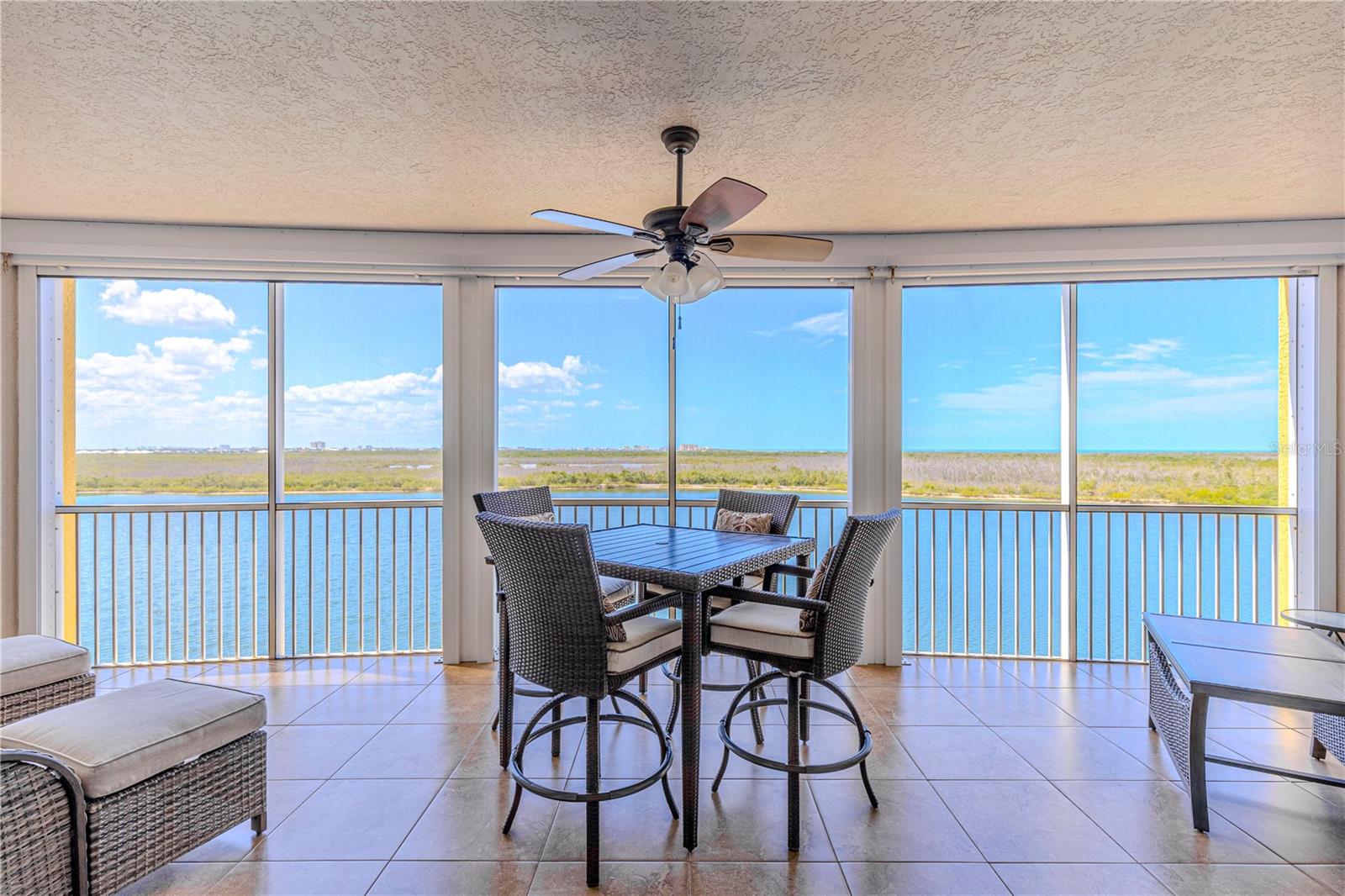 Panoramic Views
Experience luxury waterfront living at its finest in this beautiful 3-bedroom, 2-bathroom high-rise condo in the exclusive, gated community of Mastique. With over $45,000 in recent upgrades, this residence offers a private elevator leading to your own foyer and showcases stunning, unobstructed views of the Gulf of Mexico, Lake Mastique, Sanibel Lighthouse, and Fort Myers Beach.
Inside, the spacious split-bedroom floor plan is designed for both comfort and entertaining. The great room features floor-to-ceiling impact-resistant glass sliders that frame a panoramic landscape of water and preserve. The centrally located kitchen is equipped with granite countertops and stainless steel appliances. The open-concept design allows you to enjoy sweeping views while preparing meals and engaging with guests.
The primary suite is a peaceful retreat with direct access to the lanai, two walk-in closets, and a luxurious new renovated en-suite bath complete with dual vanities, an upgraded walk-in shower, soaking tub, and a private water closet with additional storage. Two guest bedrooms are thoughtfully situated on the opposite side of the condo, providing privacy for residents and visitors alike. A large laundry room offers added convenience for day-to-day tasks. Recently installed ceiling fans and Storm Smart remote-operated hurricane screens enhance comfort and security.
Step outside onto the approximately 300-square-foot tiled and screened lanai to take in breathtaking views of the lake, bay, and Gulf. You'll see parasailers over Fort Myers Beach by day and the glow of the Sanibel Lighthouse by night. The condo includes two under-building parking spaces and a dehumidified storage unit.
Mastique offers a full suite of resort-style amenities including a 6,000-square-foot clubhouse, saltwater pool and spa, a state-of-the-art fitness center, tennis and pickleball courts, barbecue areas, and a dog park with sections for both small and large pets. Residents can enjoy a one-mile walking path around the 25-acre lake, with opportunities for catch-and-release fishing, kayaking, and paddle boating. Optional lakeside cabanas are also available for purchase.
This low-density, private community is surrounded by over 700 acres of protected preserve, ensuring long-term views and privacy. Located just minutes from Sanibel, Fort Myers Beach, Bunche Beach, and a variety of shops, restaurants, and entertainment options, Mastique offers the ideal blend of tranquility and convenience. Whether you're searching for a full-time residence or a seasonal retreat, this condo is ready and waiting for you to start living your best island lifestyle.