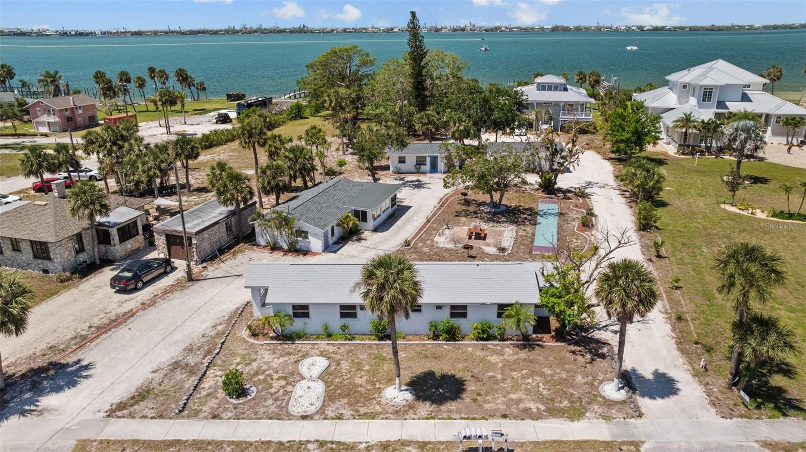 Investor Opportunity - 6 unit rental property steps from Lemon Bay, 1.5 miles to historic downtown West Dearborn Street & 2 miles to Englewood Beach! For 20+ years this property was part of the Englewood Lighthouse Resort & exudes old Florida charm with a lighthouse theme throughout. Literally just steps from the Lemon Bay Park w/public boat launch, picnic pavillion & restroom facilities. Three new roofs and all units come fully furnised. Two stand alone cottages on the western side of the property feature original terrazzo floors and large back patios w/views of gorgeous sunsets over Lemon Bay. Uses include both LTR & STR rentals. Increase value by adding a pool or hot tub and refurbish the existing shuffleboard court. Now is your opportunity to own this piece of old school Florida living for those that embrace the Salt Life!