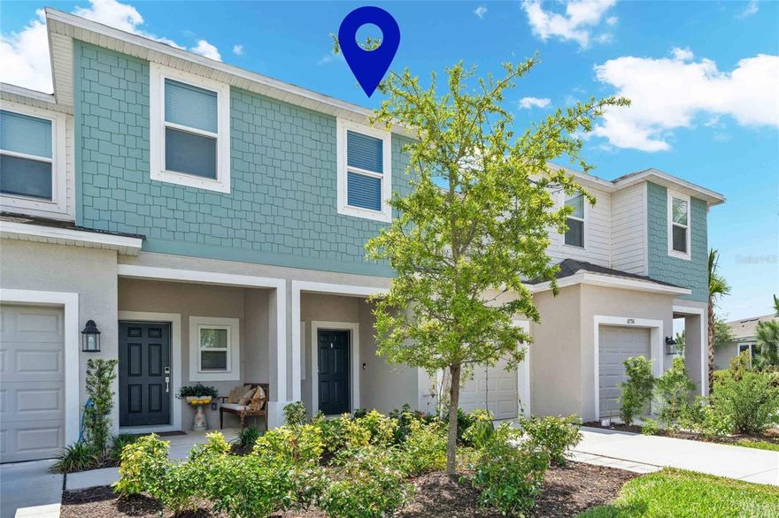 Tucked within the natural beauty of Skye Ranch, this beautifully designed Jasmine floor plan offers peaceful lake views, soft morning sunrises, and a setting that feels calm and comfortable from the moment you arrive. Positioned within one of the more private sections of the community, this three bedroom, two and a half bath townhome enjoys a spacious, residential feel with open views and a quiet sense of separation from neighboring buildings. A private driveway and one car garage provide ease of access, while a covered front entry creates a welcoming space that can be enjoyed as a quiet spot to sit and unwind. This particular building is ideally located just inside the second entrance to Skye Ranch, where a scenic, winding approach sets a more relaxed and tucked away tone, with the home immediately positioned to the left for convenient access. Inside, the home opens to a light filled, open concept design that lives effortlessly. The kitchen anchors the space with an oversized quartz island, now enhanced with upgraded pendant lighting that adds both style and warmth, along with stainless steel appliances, a walk in pantry, and recessed lighting throughout. The living and dining areas flow seamlessly together, complemented by luxury vinyl flooring throughout the first level, a custom built in TV feature wall, and a refined shiplap entry detail. Hardwired ceiling fans have been thoughtfully installed, and the small but important details have already been completed, allowing the home to feel finished, comfortable, and move in ready. A convenient half bath is also located on the first level for guests. Glass doors lead to a private outdoor living space overlooking the lake, where the openness allows you to take in the light, breeze, and natural surroundings. With no direct view into other townhomes, the setting feels open and peaceful. Upstairs, the layout continues to live well with three bedrooms, two full baths, and a convenient laundry area. The primary suite enjoys a lovely second story water view and offers a relaxed retreat with dual sinks, a walk in closet, and a private bath. Two additional bedrooms provide flexibility for guests, family, or a home office. Skye Ranch is redefining what it means to live in Sarasota, with over 25 miles of scenic trails, preserved natural spaces, and a true connection to the outdoors. At the heart of the community is Turner Park, offering dog parks, sand volleyball, tennis and basketball courts, expansive open fields, and a vibrant space for recreation and connection. The brand new Skye Ranch Elementary School, located within the community, adds an incredible level of convenience and long term value. Perfectly positioned just off Clark Road and moments from I 75 at exit 205, this location offers seamless access to everything that makes Sarasota so desirable. A direct drive leads to Siesta Key and its world renowned beaches, while UTC, Waterside, dining, and shopping are all within easy reach. It is the best of both worlds, where newer construction, nature, and convenience come together in a way that simply works. Skye Ranch represents the new Sarasota. Thoughtful, connected, and designed for the way people want to live today.