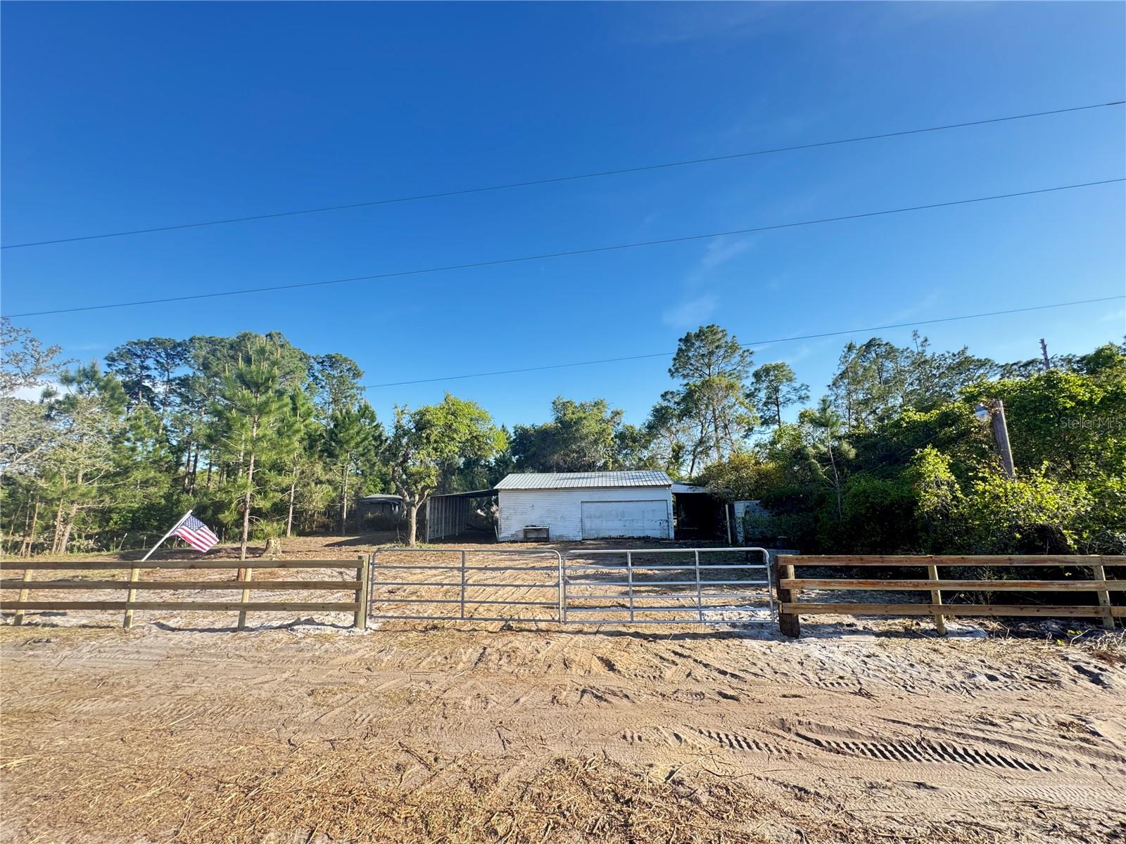 Owner financing is available: $9,500 down, the remaining amount paid over 10 years at 13%. This is almost a half-acre of land. The property had a home on it that was removed, so impact fees were previously paid. There is a small pond on the property. The property does have a nice garage structure that can be used for many purposes. The seller is unaware if there is a septic tank on the property, and also if the well is functioning.