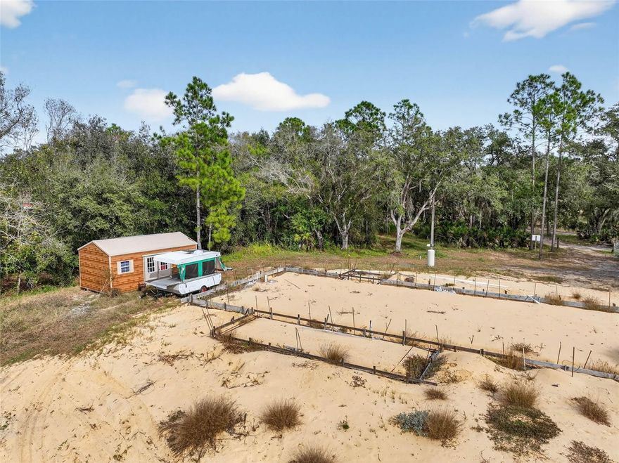 Rare opportunity to own 4.67 acres with creek access on Walk In Water Creek in Lake Wales, complete with a new artesian well, paid impact fees, and over $50,000 in upfront improvements already handled. House plans for a 3-bedroom, 2-bath, 1,980 sq ft home are included, and the foundation is already started—saving valuable time and money. Whether you're an investor or builder seeking a shovel-ready project, or a buyer ready to build your dream home in a peaceful setting, this property offers unmatched flexibility: continue with the current plans or bring your own vision. With no HOA, a private setting, survey and elevation report included, and eligibility for FHA, VA, or USDA construction-to-perm financing, this is a truly rare and ready-to-go opportunity.