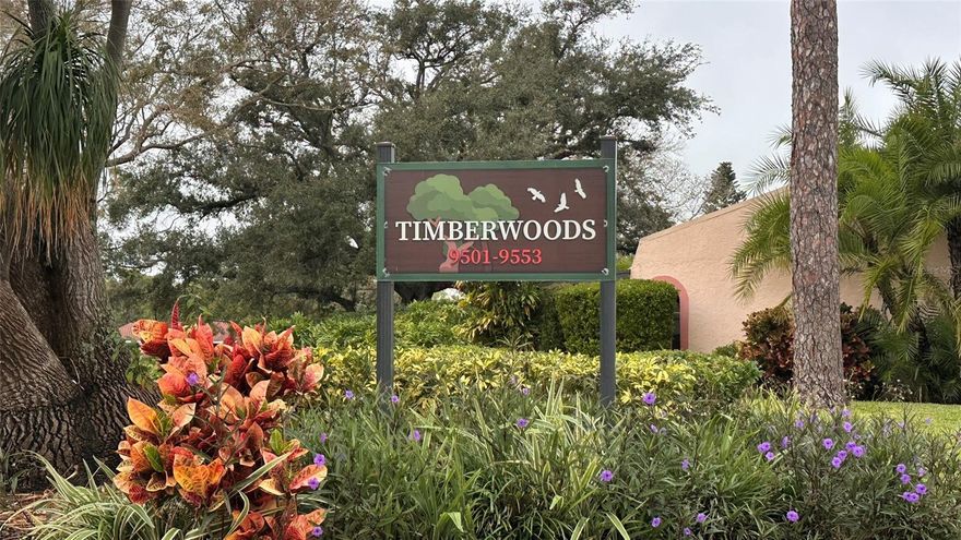 Relish your Florida Lifestyle located in central Seminole just minutes from the pristine Suncoast Beaches and popular downtown St. Petersburg. Conveniently located near dining, shopping, venues and community events with a vibe for Peaceful, green, activities, and connected to the broader Tampa Bay area without the big city hustle.  Adjacent to Seminole Lake Park. Timberwoods Condo community is a life in a Parklike setting with Mature Oaks, Swaying Palms, and Quiet Walks on the expansive property with pond water views, spacious Clubhouse, sparkling pool, tennis and pickleball. Underground utilities in this Spanish style, tile roof villas and townhomes in this picturesque village. Convenient parking carports are enclosed on three sides, and your space is attached to your corner garden home. This end unit is bright and airy with cathedral great room ceiling with sliding glass door, inside laundry area, tile and laminate floors throughout. The oversize enclosed lanai Florida Room is wall to wall windows and over two hundred square feet, double the size of others with a private door to the backyard. The interior heated square feet is 760, which is larger than other 1 bedroom, 1 bath. Extra large closets and a convenient storage closet is on the covered front patio. Your covered parking is directly next to this end unit. Appliances are approximate: Water heater 1.5 years old, HVAC 4 years (condenser newer), elect. service 9 years, disposal 9 years. Kitchen and bath are original and a blank slate for new owners as-is or your dream project upgrades when convenient. This Florida location wont last!