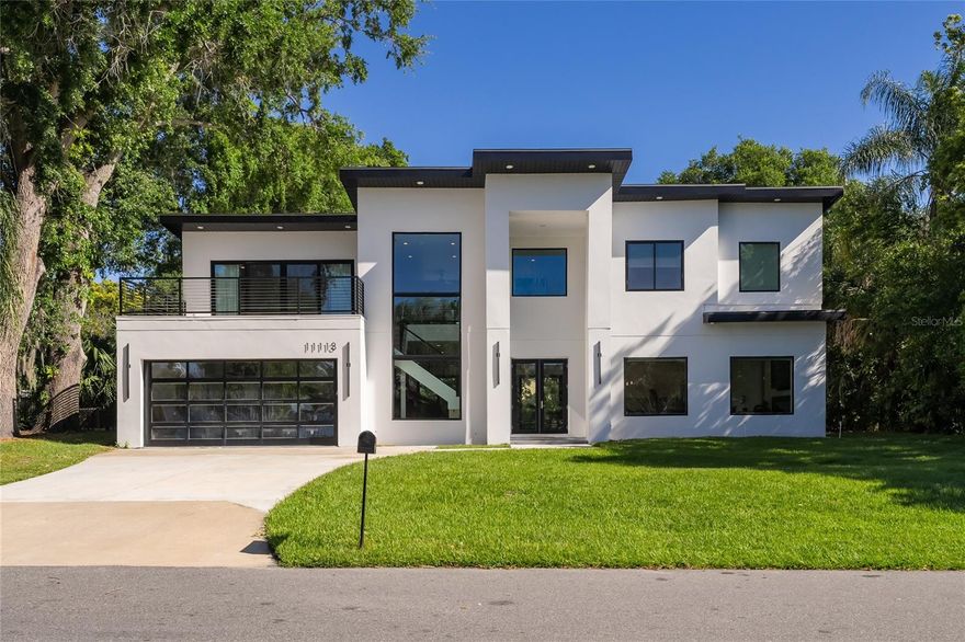 Welcome to this beautiful, unique and modern home, built less than 3 years ago. Secluded in a great sized lot and within the sought-after and exclusive City of Windermere, known for its lush nature landscape trails, recreation parks, restaurants, cozy stores, beautiful lakes, great schools and much more!!! This luxury property also has a HOA 1/24th private deeded land with lake access, dock and ramp directly across the street with a nice view from the desirable Lake Butler Chain of Lakes. As you go trough this stunning house you will find the integrated formal living and dining rooms in a very open concept as well the kitchen with upgraded appliances, flush cabinetry and a spacious walk-in pantry. This one-of-a-kind house has 5 bedrooms and 4 are suites with private bathrooms with one main suite in each floor, the upstairs main suite features a large balcony to relax with a beautiful lake view. Another advantage of tis amazing home is that it has 2 laundry facilities, one full laundry room downstairs and a laundry closet upstairs. The property features cutting edge modern design with upgraded finishes throughout, like Lighting features throughout the home, all on smart switches that you can control from your phone, floating staircase, TPO roofing, foam insulation, huge premium Jeld-Wen windows and PGT sliding doors. Stop looking, you have found your dream home among the lakes!!!         **Video available/Please text Listing agent**