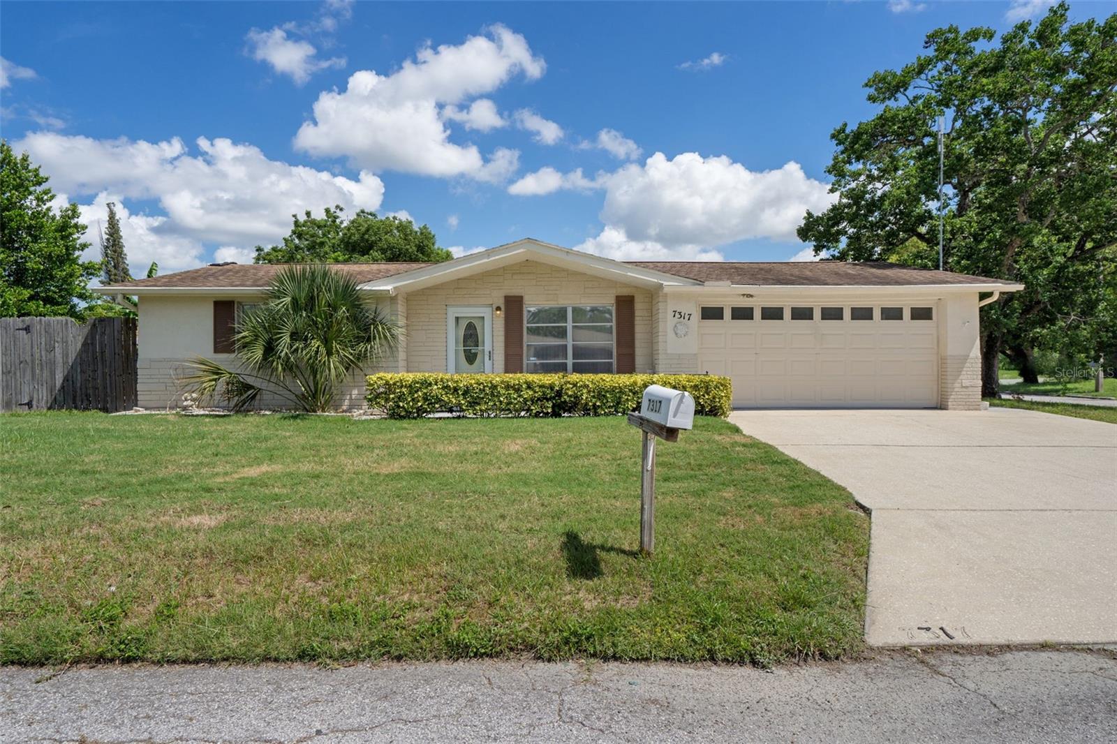BRAND NEW ROOF TO BE INSTALLED PRIOR TO CLOSING WITH ACCEPTABLE OFFER! This wonderful home is amazing opportunity, whether you are looking for a first time home, vacation getaway, empty nest or even an investment property. From the moment you drive through the quiet neighborhood and approach this well-maintained home, you'll notice the cute front yard, two car garage and charming front porch. As you enter the front door, you'll appreciate the newer laminate flooring in the main areas of the home. The spacious living room is the heart of the home, welcoming you in, and leading you the bedrooms on the left and the kitchen and dining room as you go forward. The kitchen was recently updated with soft-close cabinets and drawers, granite countertops and stainless steel appliances. The kitchen leads directly to the garage for convenience in bringing in your shopping. There is an informal dining area to the left of the kitchen and the Florida room features a wall of custom cabinets making it an ideal formal dining room, or office, playroom, den, whatever your heart desires. This room opens to the caged in pool, ready for the new owners to jump right in. The two spacious bedrooms feature newer carpeting and large closets. A full bathroom is located in the hall near the bedrooms, and an additional full bathroom is in the garage. The garage comes ready with cabinets and shelving. The back yard oasis is fully fenced with landscaping and includes a storage shed. Make your appointment today!