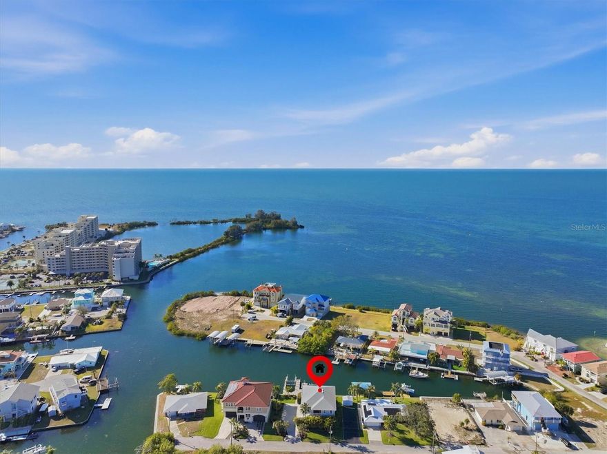 Incredible Gulf Sunset Views & Direct Gulf Boating Access – A True Boater’s Dream

Live the ultimate Gulf Coast boating lifestyle in this stunning modern 3-bedroom, 2-bath stilt home with breathtaking open Gulf views and unrestricted access to the Gulf of Mexico. From the moment you enter, sweeping water views and soaring volume ceilings create an open, airy feel that makes the home feel as if it floats above the sea.

The expansive living room is designed to showcase the Gulf, with panoramic views that pull you straight toward the water and unforgettable sunsets. The show-stopping kitchen is the heart of the home, featuring granite countertops, stainless steel appliances, light gray shaker cabinetry, wine cooler, and a bar-height island that comfortably seats six—perfect for gathering after a day on the water.

Wake up every morning to Gulf views from the primary suite, which offers a spa-style walk-in shower and granite vanity with dual sinks. The spacious guest bedrooms also enjoy water views, while the guest bath features a granite-topped vanity, generous storage, and a walk-in shower. Wood-look flooring throughout and a dedicated laundry room provide easy-maintenance coastal living with timeless charm. A covered rear second story porch is the perfect place for cocktails was you watch the sun melt into the Gulf.

Outside is where this property truly shines for serious boaters. Situated on 89 feet of concrete seawall along a saltwater canal with direct Gulf access and no fixed bridges, the home is tucked into a protected inlet—shielding your boats and dockage from harsh Gulf winds and waves. Over $200,000 in dock improvements create a dream setup: a 24,000-lb boat lift with dockage on both sides accommodating a 30+ foot vessel, a 10,000-lb lift currently configured for jet skis (easily convertible for a V-hull or pontoon), oversized Duratek fixed dock with power and water at multiple points, plus a separate floating dock. This setup effortlessly accommodates a wide variety of watercraft.

Spend your days watching dolphins and manatees swim behind your home while fishing for redfish, snook, and snapper right from your dock—or head straight out to the open Gulf in minutes.

Welcome to Hudson Beach, a true boater’s paradise just north of Tampa along Florida’s scenic Gulf Coast. This laid-back waterfront community captures the spirit of old-Florida coastal living—often compared to Key West in the 1970s—with its relaxed vibe, working waterfront, and salt-air culture. Boating isn’t just a hobby here; it’s a way of life.

Marinas line the shoreline, waterfront tiki bars and local restaurants overlook nightly sunsets, and the small public beach becomes a natural gathering spot for boaters and neighbors alike. A thriving commercial seafood industry, including shrimping and stone crabbing, keeps Hudson’s maritime heritage alive and woven into everyday life.

Conveniently located along US-19, Hudson Beach offers easy access to shopping, dining, medical facilities, and daily necessities, with Tampa International Airport about an hour away and Orlando attractions within a 90-minute drive.

This is Gulf Coast living at its finest—where days revolve around the tides, sunsets are a nightly event, and the boating lifestyle isn’t just imagined, it’s lived.