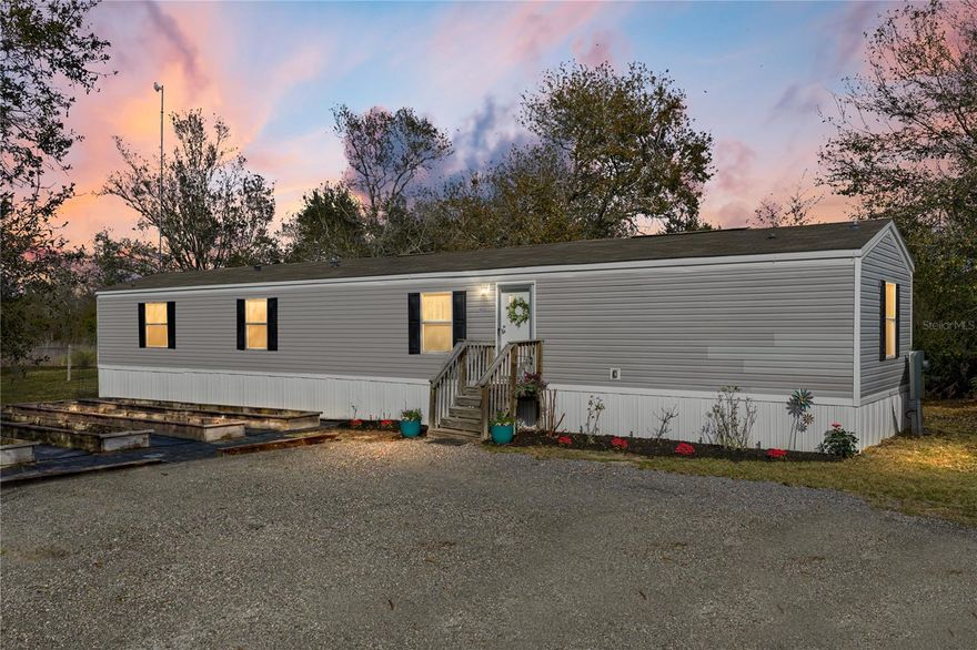 Welcome to 4553 Cedar Hammock Street in Lake Wales! This meticulously maintained 2021 manufactured home sits on a spacious 1.10-acre lot, offering room to roam, relax, and enjoy country living with no HOA. Nearly everything on this property was built in 2021 — including the home, well, septic system, and the outdoor shed with electricity, providing practical storage or workshop space. Inside, you’ll appreciate a clean, modern interior with no carpet — perfect for easy maintenance and allergy-friendly living. The thoughtfully designed layout offers comfortable living spaces that flow effortlessly throughout. Step outside to your 2024 built back porch deck, ideal for morning coffee, outdoor dining, or simply enjoying the peaceful surroundings. The large property also features garden beds with irrigation, ready for planting flowers, herbs, or your own vegetables. With abundant outdoor space, dependable utilities, and thoughtful upgrades, this property offers a rare combination of comfort, convenience, and value. Don’t miss your chance to see this move-in ready home on over an acre — schedule your private tour today!