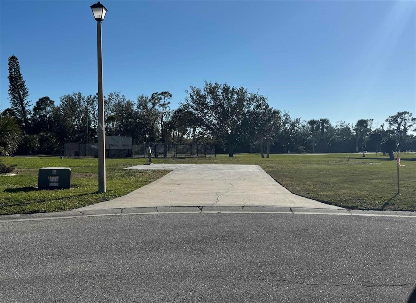 This great lot is ready for your new home in the beautiful Gasparilla Pines 55+ Community. Just a short drive to the Gulf beaches of Boca Grand Island and Manasota Key. Electric, public water & sewer availability for hook up and concrete pad is in place. Boating, fishing, golfing, nature trails, shopping and dining are all just a short drive. LOW HOA FEES of only $200 a year and you OWN YOUR OWN LAND. Come make your Florida paradise dream home a reality.