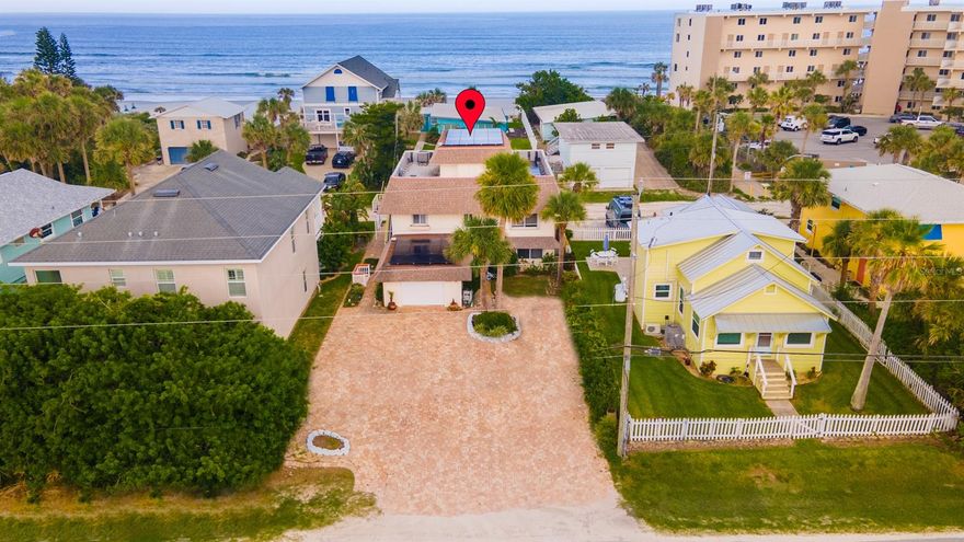DUPLEX + INLAW SUITE - Fantastic beach getaway in short term rental zone. Enjoy all the beauty and fun that New Smyrna has to offer in your private 3 bedroom/3 bathroom home but with the ability to make some rental income when you are not there in the full apartment and/or inlaw suite. 2nd and 3rd floor are the main living area featuring 2 bed/2 bath on 2nd floor with main living area, kitchen and dining and a loft bedroom suite on 3rd floor w/ walk in closet, full bath and peek of the ocean. Main kitchen updated with light oak cabinetry, glass cabinet features and wine rack, electric flattop stove, microwave, dishwasher, stainless fridge and trash compactor. 1st floor features an in-law suite with bedroom, walk in closet, bathroom, living area and kitchenette with separate entrance. South side of 1st floor features full apartment with 1 bedroom, office, bath, kitchen and living area, tile throughout. Laundry is in the oversized 1 car garage. Home features hurricane shutters, natural gas, Generac generator, solar panels for electricity. All units are separate A/C with 2 units for the 2nd and 3rd floors. All appliances convey. Beach access to the north and south of the same block. Pavered driveway entrance on S Atlantic side with room to park a boat, home runs front to back S Atlantic to Hill St. Chair lift access on stairway to 2nd floor.