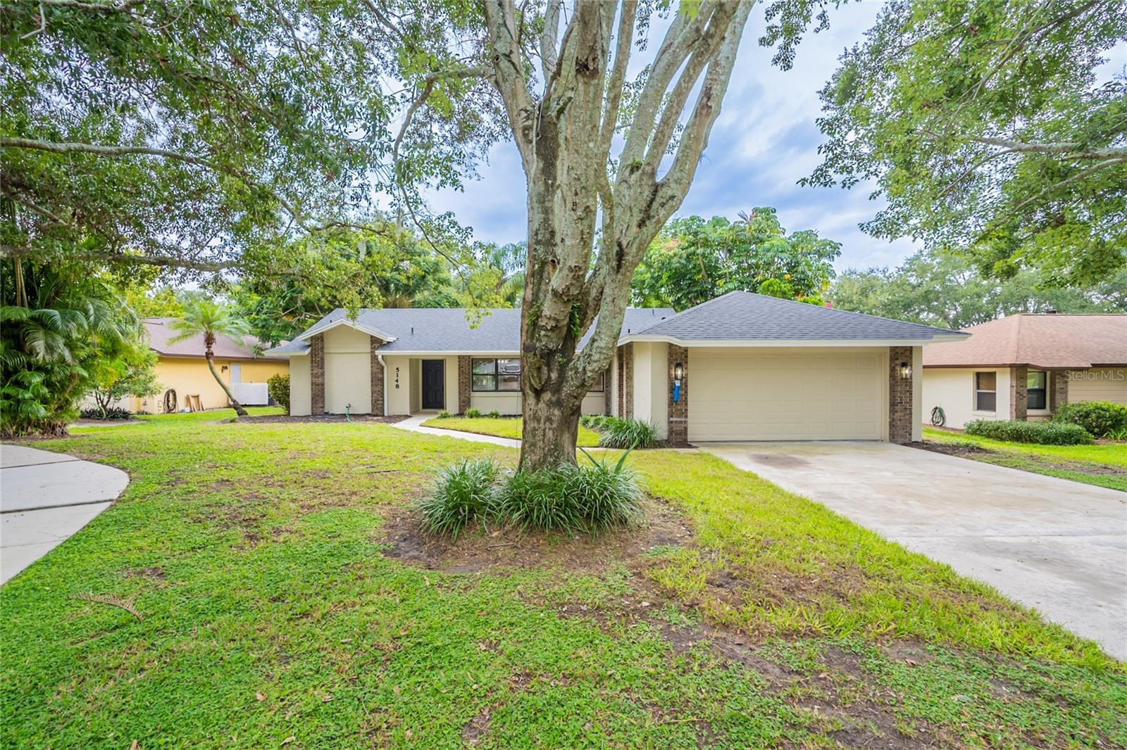 Here is your chance to make this NEWLY UPDATED, single-story, BLOCK home your very own! Located in the beautiful, quiet neighborhood of Silver Woods, and nestled among mature trees along a CUL-DE-SAC! The outside features charming brick accents, fresh EXTERIOR PAINT, and from the LONG DRIVEWAY is a lovely paved walkway leading to the covered front entry. Greeted by vaulted ceilings, complete with NEW ceiling texture, crown molding, and fresh INTERIOR PAINT throughout. The living room boasts a cozy, wood-burning, brick FIREPLACE. The inside is loaded with upgrades, including brand NEW baseboards, FRESH CARPET in the bedrooms, and LUXURY VINYL PLANK flooring throughout the living and dining rooms, kitchen, and wet areas. The renovated kitchen is fully equipped with brand NEW white cabinets, QUARTZ countertops, and STAINLESS STEEL appliances, including a dishwasher, range, and microwave. The laundry room is INSIDE with washer and dryer hookups and cabinets for storage. Both bathrooms have been updated with modern finishes, and NEW vanities, toilets, shower tiles. The TWO double-pane sliding glass doors lead to the screened-in and partially-covered patio, which makes the perfect space for entertaining or relaxing on a warm, sunny day. The backyard is FULLY FENCED with vinyl fencing and offers so much space for playing, gardening, you name it! Other NEW features include a BRAND NEW ROOF, water heater, fan/light fixtures, hardware, and more! Located close to Orlando's best attractions, shopping, restaurants, major roadways, and more! Schedule a showing today!