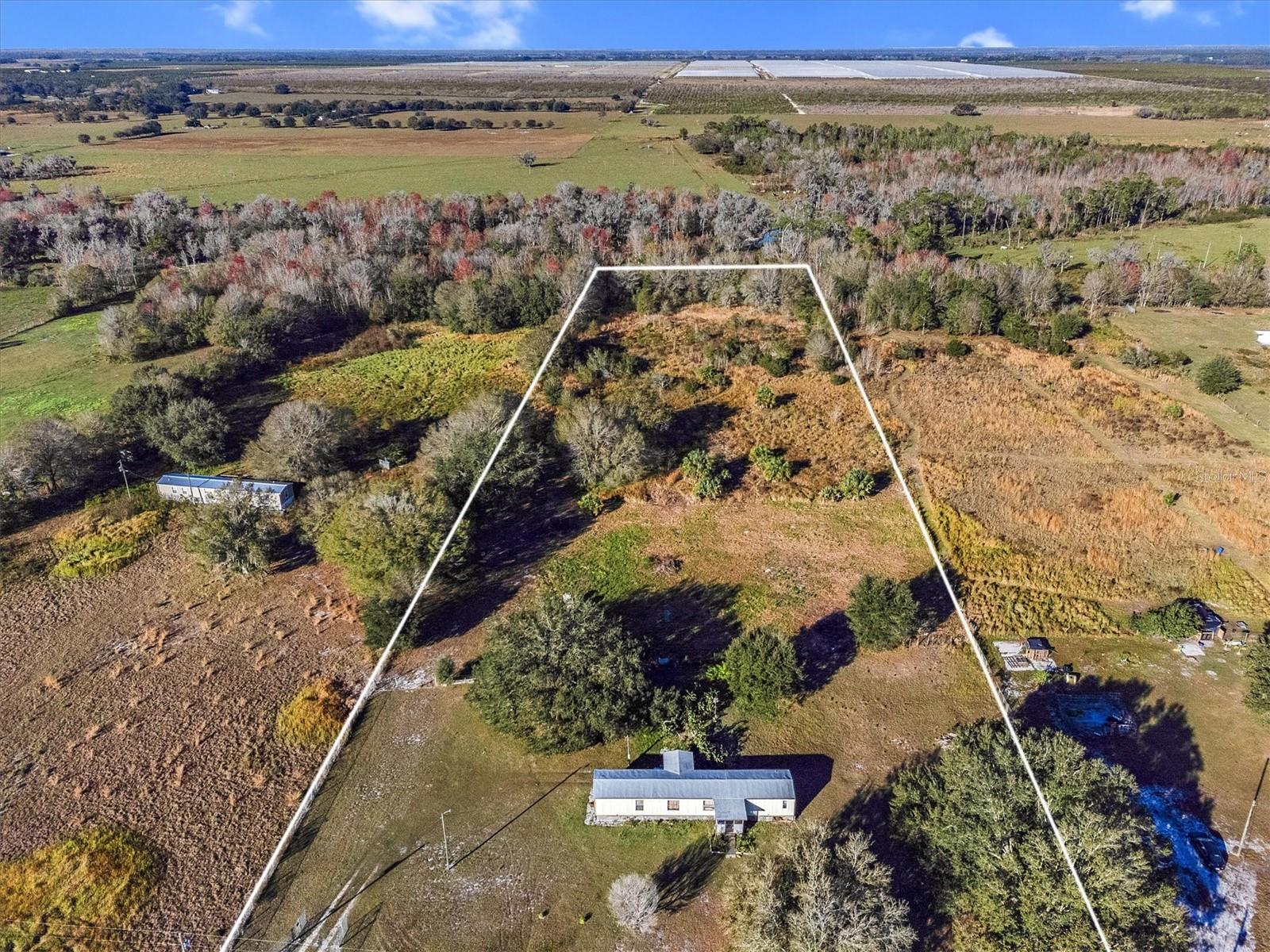 Welcome to your country retreat in Frostproof, Florida, situated on 5.18 acres off US HWY 98, with close proximity to Lake Wales, Avon Park and Fort Meade. This property, ideal for horses and livestock, features a 4-bedroom, 2-bath single wide mobile home, though in need of TLC, presents a golden opportunity for a cash buyer or investor. This unique space is brimming with potential. Sold AS-IS, the fenced-in grounds invite you to envision and create your own rural haven. Just minutes away, explore the beauty of Crooked Lake Wildlife and Environmental Area, a nature preserve boasting great hiking and horse-riding trails, providing endless outdoor adventures right at your doorstep. In this welcoming community, enjoy the freedom and flexibility to make this property truly your own. Seize the chance to embrace a lifestyle that blends nature, privacy, and potential on this expansive piece of Florida paradise.