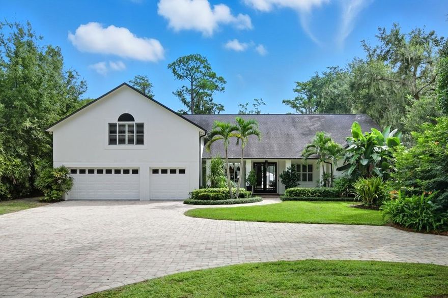 Discover refined lakefront living on nearly six acres of private, gated grounds along pristine Lake Pickett. Thoughtfully renovated, this 4,094 Sq Ft home blends modern design with timeless comfort, featuring 4 bedrooms and 4 baths, to include a private upstairs retreat with ensuite bath and abundant storage.
The central kitchen (2023) anchors open living and dining areas (2023), where walls of glass sliders invite natural light and serene lake views. Seamlessly connected to the outdoors, the main living spaces open to an expansive pavered deck and heated pool (2022), complemented by a retractable screened porch and outdoor shower (2022)—perfect for resort-style relaxation and entertaining. The backyard is enhanced with custom fencing that beautifully frames the property while offering maximum privacy and security.
White oak wood-look ceramic tile extends throughout the first floor (2023), uniting style and durability. The primary suite, renovated in 2023, offers a calm, modern retreat with quiet elegance. A separate guest wing defines multigenerational living, while a versatile first-floor flex space adapts effortlessly for an office, media room, or recreation. This expertly designed three-way split floorplan balances privacy, comfort, and connectivity, creating ideal spaces for family, guests, and lifestyle needs alike.
Beyond the home, the estate’s lush foliage, fruit-bearing trees (cherry, mango, dragonfruit), and landscaped grounds create an intimate sanctuary. The private drive from the gated entrance showcases the estate’s exceptional outdoor amenities, including expansive grounds for recreation and adventure, a stand-alone garage for storage of outdoor toys, and ample parking for trailers, RVs, boats, and off-road vehicles. Additional features include a pergola greenhouse with timed water sprayers to cultivate your green thumb, a lakeside gazebo, a water-toy storage shed, and a covered pad for grilling—perfect for both leisure and entertaining.
Situated on expansive skiable lakefront acreage with long water views and mature oaks, this exceptional property balances privacy, sophistication, and effortless indoor-outdoor living—all just minutes from east Orlando conveniences and easy access to the 408 and 417.
