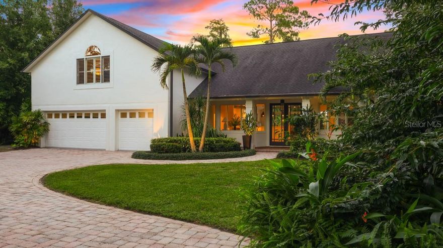 Discover refined lakefront living on nearly six acres of private, gated grounds along pristine Lake Pickett. Thoughtfully renovated, this 4,094 Sq Ft home blends modern design with timeless comfort, featuring 4 bedrooms and 4 baths, to include a private upstairs retreat with ensuite bath and abundant storage.
The central kitchen (2023) anchors open living and dining areas (2023), where walls of glass sliders invite natural light and serene lake views. Seamlessly connected to the outdoors, the main living spaces open to an expansive pavered deck and heated pool (2022), complemented by a retractable screened porch and outdoor shower (2022)—perfect for resort-style relaxation and entertaining. The backyard is enhanced with custom fencing that beautifully frames the property while offering maximum privacy and security.
White oak wood-look ceramic tile extends throughout the first floor (2023), uniting style and durability. The primary suite, renovated in 2023, offers a calm, modern retreat with quiet elegance. A separate guest wing defines multigenerational living, while a versatile first-floor flex space adapts effortlessly for an office, media room, or recreation. This expertly designed three-way split floorplan balances privacy, comfort, and connectivity, creating ideal spaces for family, guests, and lifestyle needs alike.
Beyond the home, the estate’s lush foliage, fruit-bearing trees (cherry, mango, dragonfruit), and landscaped grounds create an intimate sanctuary. The private drive from the gated entrance showcases the estate’s exceptional outdoor amenities, including expansive grounds for recreation and adventure, a stand-alone garage for storage of outdoor toys, and ample parking for trailers, RVs, boats, and off-road vehicles. Additional features include a pergola greenhouse with timed water sprayers to cultivate your green thumb, a lakeside gazebo, a water-toy storage shed, and a covered pad for grilling—perfect for both leisure and entertaining.
Situated on expansive skiable lakefront acreage with long water views and mature oaks, this exceptional property balances privacy, sophistication, and effortless indoor-outdoor living—all just minutes from east Orlando conveniences and easy access to the 408 and 417.