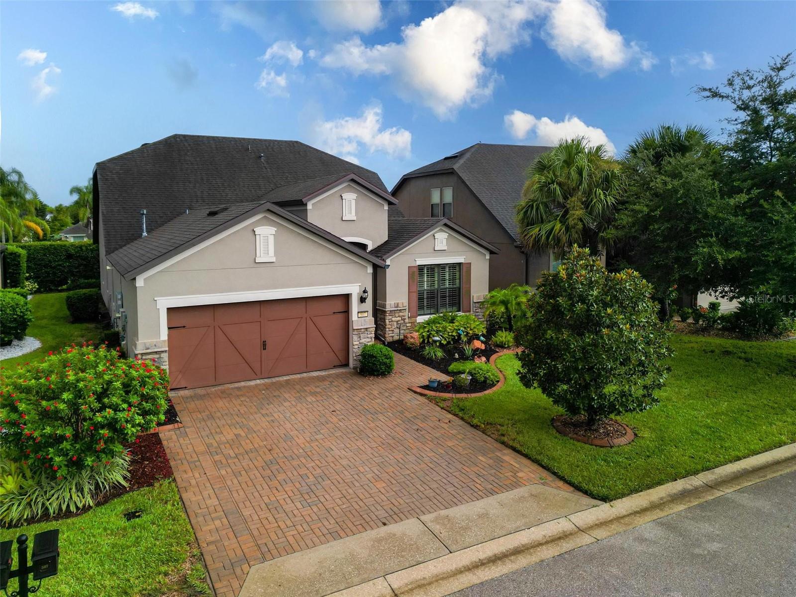 Welcome to 507 Cadiz Dr. nestled in the 24-hr guard-gated Del Webb Orlando 55+ neighborhood in the picturesque city of Davenport, FL. This spacious home boasts a well-designed floor plan spanning across a total 2,616 square feet. Upon entering, you'll be greeted by a welcoming foyer that leads you into the heart of the home, where beautiful wood floors and a warm ambiance await. The living room is an inviting space, perfect for relaxation or entertaining guests. With its elegant design and cozy atmosphere, it sets the stage for memorable moments with loved ones. The kitchen showcases modern stainless appliances with a gas stove, overhead and under cabinet lighting, ample cabinet space, 1-1/4" granite countertops and a convenient breakfast bar. Whether you're preparing a gourmet feast or whipping up a quick meal, this well-appointed kitchen is sure to inspire your inner chef. The master suite is a true retreat featuring a generously sized bedroom, a walk-in closet, and an en-suite bathroom with walk-in shower and dual sinks. The additional bedrooms, den/office/bedroom, and bonus room are spacious and versatile, accommodating various needs and lifestyles. The backyard provides complete privacy with hedges lining the windows of the enclosed FL Room. Home is a true 1.5 story floor plan with a fourth bedroom and bonus room above. Conveniently located, provides easy access to a range of both community center and area amenities. Inside, the community offers bocce ball, tennis, pickleball, dog park, fitness center, indoor lap pool, outdoor pool and spa, fire pit, arts and crafts room and tavern!! There are too many clubs to mention as well!! Enjoy proximity to shopping centers, restaurants, Orlando theme parks, and entertainment options, ensuring you have everything you need within reach. Additionally, the home is situated in close proximity to I-4. Go West or East on I-4 to go directly to the beaches. Other improvements include; epoxy-coated garage floor (2022), HVAC & thermostat replaced (2022), under stair storage added in craft room (2016), lanai remodeled into a finished 4-seasons room (2015), garage extended 4-ft (2013), in-wall pest control system (2013), added additional cabinetry in kitchen bathroom and laundry room (2013). Paver driveway was widened 3-ft on each side. Soar panels were added in (2024) which led to huge monthly savings. Don't miss the opportunity to make this remarkable property your own. Schedule a showing today and experience the allure of 507 Cadiz Drive in person. This could be the home you've been waiting for – a place where comfort, style, and convenience intersect seamlessly.