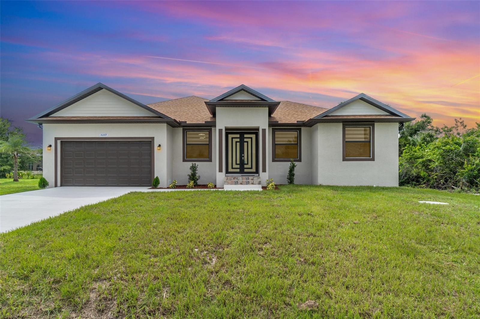 New construction in South Gulf Cove with clean, modern lines and seamless indoor-outdoor living. Single-story 3BR + office / 2BA / 2-car garage. Open concept with large-format porcelain tile throughout, striking frosted-glass double entry, slat accent wall and designer lighting. Show-stopping kitchen features an XL waterfall quartz island, shaker cabinetry, mosaic backsplash, stainless appliances and fixtures. Owner’s suite has dual vanities, frameless glass shower and a freestanding soaking tub. Bright secondary bedrooms with modern fans and zebra shades. Generous laundry room with sink and cabinets. Relax on the covered lanai with wet bar overlooking the backyard—perfect for grilling and entertaining. Minutes to Gasparilla Rd/FL-776, marinas, beaches and golf. Move-in ready and easy to show.