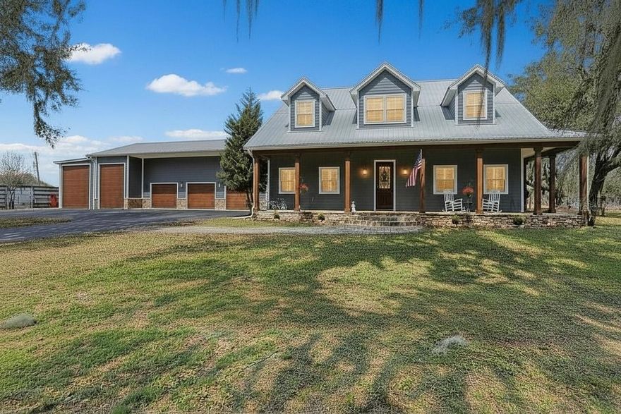 One or more photo(s) has been virtually staged. Custom 2019 Home on 1 Acre | Guest Suite | RV Garage | Workshop | Massive
Patio.Virtually Staged.Preferred lender offering 1% of the loan amount (up to $9,000) as a buyer closing cost credit if loan funds with lender. Dade City's Best Kept Secret — A Custom Masterpiece on a Private Acre Rare finds like this don't come along often. Built in 2019 by a general contractor as his personal forever home, this one-of-a-kind property was designed with no compromises — and it shows in every detail. Nestled on a private acre with sweeping open field views, mature shade trees, and zero HOA or CDD, this is the freedom and craftsmanship today's buyers are searching for.
With over 3,000 sq ft, 4 bedrooms, and 3.5 baths, the thoughtfully designed layout includes a private mother-in-law suite exceeding 500 sq ft — complete with kitchenette, bedroom, full bath, private exterior entrance, interior access, and its own septic system. Whether you're thinking multigenerational living, a home business, or rental income, the flexibility here is unmatched.
From the moment you step inside, soaring ceilings finished in white pine and anchored by authentic 200-year-old reclaimed barn wood beams, posts, and custom doors set the tone — warmth and character you simply cannot replicate in new construction.
The chef's kitchen is the heart of the home, appointed with Solostone quartz countertops, a Café glass cooktop, wall-mounted Café double ovens, a dedicated coffee bar, drink mini-fridge, large island, and a peninsula with bar seating for four. Roll-out drawers on most base cabinets make everyday living effortless. All appliances convey, including the brand new dishwasher.
The primary suite is tucked on the main floor and features granite shower tile, dual shower heads, and a rain head system. Porcelain tile flows throughout the first floor, while the second level offers LVP flooring, two oversized bedrooms, a full bath, and a show-stopping loft with an authentic brick wall — perfect for a media room, home office, playroom, or your best Zoom backdrop.
Outdoor living is truly exceptional. Three sides of wrap-around paver porch, a massive 36' x 42' patio built for entertaining, a fully fenced yard, and a custom children's play palace create a backyard experience unlike anything else on the market. And for the right buyer — a stunning private swim spa is available. Submit a full price offer and the swim spa conveys. It does not remain with the home otherwise.
From the exterior, six garage bays offer incredible versatility. One serves as the mother-in-law suite entrance. Another is a workshop enthusiast's dream, complete with a mezzanine offering an extra 500+ sq ft of overhead storage. The enclosed RV garage features a 50-amp plug and spray foam insulation — room for all the toys, vehicles, and hobbies you've been waiting to indulge.
Built to last and built to perform: 26-gauge commercial metal roofing, open-cell spray foam insulation, Hardie concrete siding, 2x6 pressure-treated framing, generator prep with wiring and transfer switches, and a private wrought iron gated entrance with fenced front yard.
All of this in the rolling hills of Dade City — a charming part of Florida which is a community celebrated for its oak-lined streets, horse properties, unique local shops, and beloved events like the Kumquat Festival. Country living at its finest, with easy access to Tampa and Wesley Chapel.