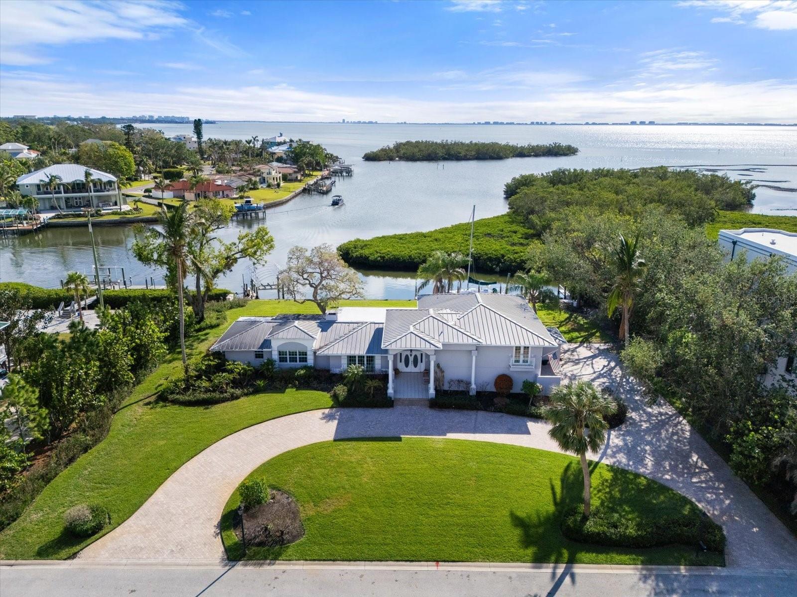 Step into luxury with this exceptional colonial estate situated in the exclusive gated community of Hawks Harbor, where waterfront living meets unparalleled elegance. This rare gem offers 4 bedrooms and 3 bathrooms, all set on an impressively spacious 30,126-square-foot double lot.
This property represents an incredible opportunity for visionaries and boating enthusiasts alike.
As you enter, the stunning water views immediately capture your attention. With 181 feet of seawall along a deep-water canal, this property is truly a boater’s paradise. Bring your yacht! Picture yourself embarking on morning paddles among gentle manatees or enjoying dinner by boat at one of the area’s acclaimed waterfront restaurants.
The thoughtfully designed layout features two well-appointed bedrooms on the main floor, each offering direct access to a screened-in lanai perfect for entertaining or tranquil relaxation. Ascend to the upper level to discover the exquisite spacious primary suite, complete with sweeping views of the islands, a private balcony, his and her walk-in closets outfitted with custom built-ins, dual vanities and an additional bedroom and bath that provide comfort and privacy.
The first floor showcases a brand new kitchen updated January 2025, complemented by an oversized laundry room for added convenience. A side garage offers plentiful parking, while the charming circular driveway enhances the property’s curb appeal.
With direct access to Sarasota Bay and no bridges standing between you and the open water, you’ll be just minutes away from the area’s beautiful, world-renowned beaches. The prime location of Hawks Harbor places you conveniently between Downtown Bradenton and Downtown Sarasota, providing easy access to Sarasota Airport, fine dining options, shopping hotspots, St. Armand's Circle, Anna Maria Island, Lido Key, IMG Academy, and much more.
Whether you envision a luxurious renovation or wish to embark on a fresh build, this property offers a blank canvas brimming with possibilities.
Don’t wait—experience the charm and allure of life in Hawks Harbor. Contact us today to schedule your exclusive tour and explore the remarkable opportunities that await you in this waterfront paradise!