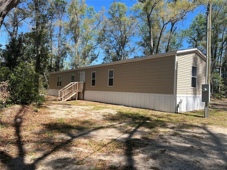 Enjoy peace and privacy with this like-new 2024 singlewide mobile home situated on a beautiful 1.13-acre wooded lot in Branford, Gilchrist County. This 3-bedroom, 2-bath home offers 1,140 square feet of comfortable living space and features an all-electric setup for efficiency and convenience. Inside, you’ll find an open living room and dining room combination, perfect for relaxing or entertaining, along with a spacious kitchen with a breakfast bar for casual meals and gatherings. The location is ideal—just minutes from the Suwannee River and downtown Branford, giving you quick access to shopping, dining, and outdoor recreation. Whether you're searching for a vacation getaway, Airbnb opportunity, investment property, retirement retreat, or a peaceful place to call home, this property offers the perfect blend of comfort and privacy. If you’re looking for quiet country living with modern convenience, this is the one!