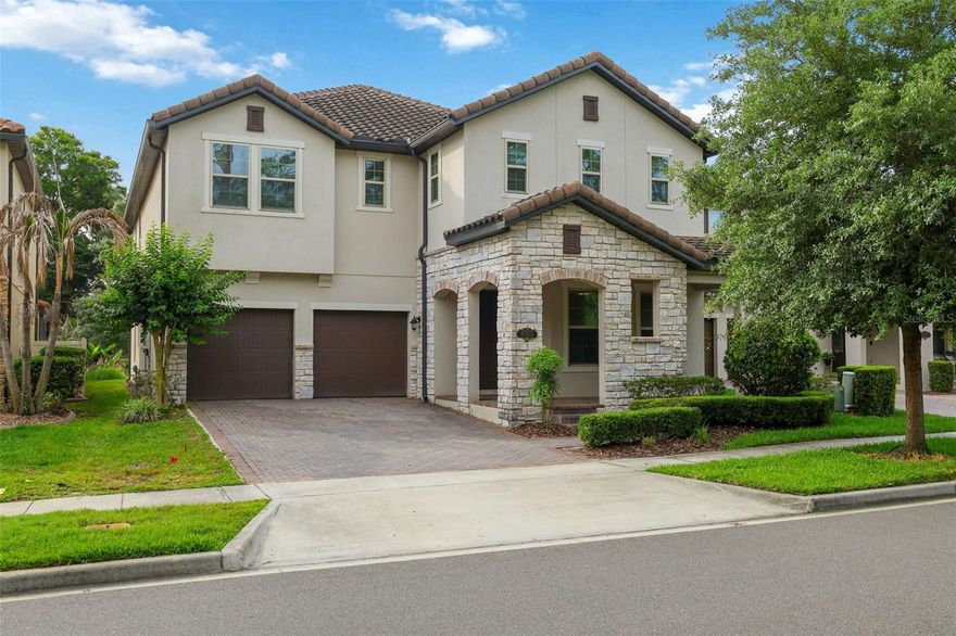 One or more photo(s) has been virtually staged. Experience luxury living in the highly sought-after “Cascade” floor plan, featuring an upgraded stone-accented exterior and tile roof in the desirable Windermere Isle community. Situated on a premium oversized lot with a HUGE backyard and mature trees for added privacy, this exceptional home offers the perfect blend of relaxation, comfort, and entertainment. Enjoy peaceful conservation views from the charming front porch, while the rear of the home provides enchanting nightly views of Disney fireworks lighting up the sky. Inside, meticulous attention to detail is evident throughout this thoughtfully designed home. The main level features two bedrooms, including one ideal for a home office with double entry doors and a walk-in closet. The dream kitchen showcases upgraded cabinetry with crown molding, Quartz countertops, gas cooktop, upgraded double convection wall ovens, upgraded French door refrigerator, a generous walk-in pantry, and a convenient 7’ x 5’ pocket office complete with built-in desk and cabinetry. Wood-look tile flows throughout the downstairs living areas, complemented by engineered hardwood flooring in the dining room and great room. A functional drop zone near the garage includes upgraded lower cabinetry topped with Quartz counters. Beautiful wood stairs lead to the second floor, where you’ll find a sprawling loft/bonus room, spacious media/game room and an oversized laundry room equipped with washer, dryer, and laundry sink. Additional highlights upstairs include a half bath, abundant storage closets, and two secondary bedrooms with walk-in closets connected by a Jack-and-Jill bath. The luxurious primary suite is a true retreat, featuring a tray ceiling and stunning nightly Disney fireworks views. The spa-inspired primary bath offers a large soaking tub, an oversized walk-in shower with upgraded glass enclosure, dual vanities, and an expansive 13x12 walk-in closet. Additional features include 8-foot doors throughout, ceiling fans in all bedrooms, LED lighting and a natural gas tankless water heater for ultimate convenience and efficiency. Vinyl fencing is already installed on three sides by neighboring properties. HOA includes lawn maintenance and 1 GIG Spectrum internet and cable with 4-5 streaming choices. Community pool, playground and walk path around scenic pond. Ideally located with convenient access to shopping, dining, entertainment, and major roadways, this remarkable home perfectly combines luxury, functionality, and everyday comfort. Don’t miss the opportunity to make this extraordinary property your own — schedule your private tour today!