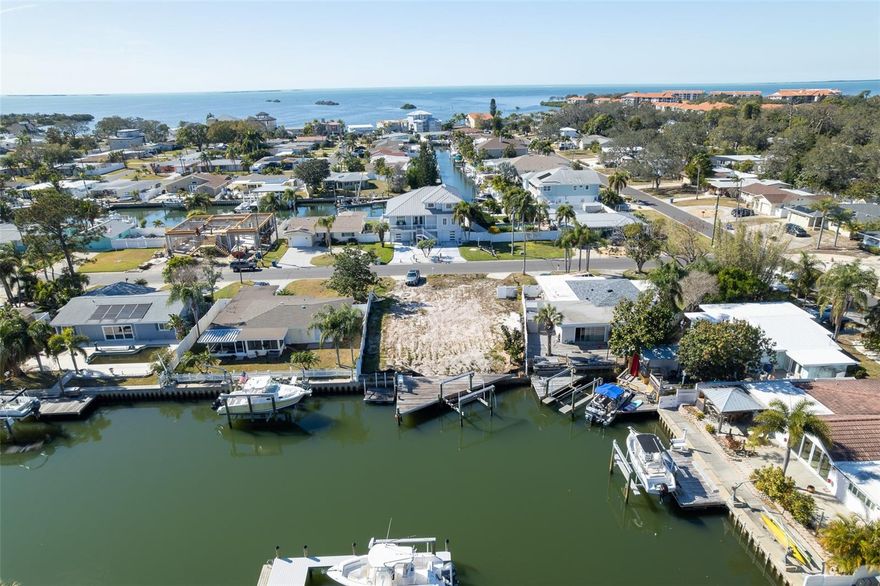 Rare chance to own a build-ready saltwater waterfront lot offering sailboat access just 2,000 feet from the Intracoastal Waterway. With no bridges to the Gulf, enjoy seamless access for cruising and offshore adventures. Golf enthusiasts will appreciate being just two short miles from the prestigious Innisbrook Golf Resort, home to world-famous championship courses. Spend your days teeing off or enjoy some of the finest snook and tarpon fishing anywhere — right from your dock or while cruising to local favorites like Honeymoon Island, Three Rooker Sandbar, and Caladesi Island.This prime location delivers the best of Florida living with A rated schools,  nearby state parks and biking trails, and convenient access to culture and travel. You’re just two miles from the Leepa-Rattner Museum of Art and St. Petersburg College, minutes from the Pinellas Trail — a scenic 47-mile paved pathway from St. Petersburg to Tarpon Springs — and only 22 miles from Tampa International Airport.The former home has been professionally demolished, leaving a clean, cleared parcel ready for immediate construction. An existing dock with boat lift is already in place for instant waterfront enjoyment. Custom building plans are complete, and a local, reputable builder is prepared to begin construction immediately. Waterfront opportunities of this caliber are increasingly rare. Competitively priced and truly move-forward ready, this extraordinary lot won’t last long.