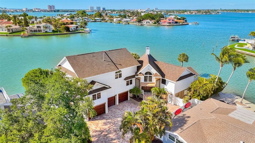 Nestled in the heart of one of America’s Top Rated Beach communities, St. Pete Beach, this extraordinary custom-built home boasts awe-inspiring panoramic water views of Boca Ciega Bay. Spanning 5 bedrooms, 3 and a half bathrooms, and nearly 4,000 square feet of opulent interior living space, all set on a sprawling 0.29-acre lot. Distinguished by its unparalleled opportunity of a lifetime to own 250 feet of waterfront frontage, this three-story elevated residence is a testament to pride of ownership, cherished by the same owner for three decades. A recent addition of a brand-new roof in 2022 ensures lasting peace of mind for years to come. Revel in the convenience of a 3-car garage, complemented by an additional garage door at the rear, perfect for housing your jet ski. The ground floor presents abundant storage options and versatile flex spaces ideal for game or entertainment rooms. Ascend the grand staircase leading you through double front doors to the second-floor main living area. An open floor plan and a wall of sliding doors perfectly frame the picturesque water views centered by a gas fireplace. The expansive kitchen boasts wood cabinetry, granite countertops, a large island, a gas range, and built-in double ovens. Additionally, the second floor hosts 3 bedrooms (one being used as an office), 2 and a half bathrooms, a wet bar perfect for entertaining friends and family, and a generously sized laundry room. The third floor retreat unveils an oversized owner’s suite with dual walk-in closets and a lavish ensuite bathroom featuring a large soaking tub, separate vanities, and a standup shower. An additional double bedroom upstairs offers versatile usage, perfect for a nursery or guest suite. Step outside to discover your own personal oasis. The wrap-around back deck overlooks the tranquil waters of this corner lot and a glistening pool and spa. Enjoy waterfront living at its finest with a dock providing access to deep sailboat water, a 45ft x 16ft wet slip, and a 10,000 lb electric lift, mere minutes from the Gulf of Mexico by jet ski or boat. Fish off your dock, grab a paddleboard or kayak and watch sea life pass you by. Nestled within the coveted boating community of Bahia Shores, this residence provides the dream beach lifestyle living experience with St. Pete Beach's pristine sands, only a five-minute stroll away while centrally located between the quaint coastal towns of Treasure Island and Pass-A-Grille Beach. Immerse yourself in the vibrant town of St. Pete Beach, where leisurely strolls along Corey Ave lead to charming boutiques and a plethora of dining options, including a sure favorite, Snapper’s Sea Grill and one of the local’s hidden favorite spots, Jimmy B’s Beach Bar. For a taste of refined luxury, venture to the iconic Don Cesar Hotel just a short drive away. While many residents prefer walking, biking, or golf carting around this coastal area, the Tampa Bay area delights with its array of attractions. Explore nearby Downtown St. Petersburg's renowned museums and trendy eateries, or catch a thrilling game featuring the area's top sports teams—the Buccaneers, Rays, Rowdies, and Lightning. With Tampa International Airport a mere 35 minutes away, both business and leisure travel are effortlessly accessible. Welcome to the epitome of luxury coastal living, where every detail has been meticulously crafted for your enjoyment and relaxation for years to come.