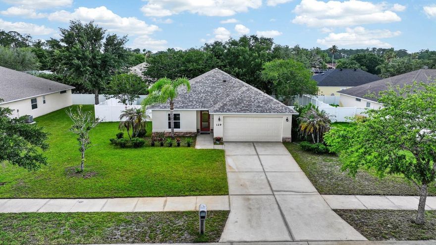 One or more photo(s) has been virtually staged. Welcome to 129 Grey Dapple Way, a beautifully crafted Johnson Group Home located in the highly sought-after Tymber Crossings community in the heart of Ormond Beach. Built by one of the area's most respected builders, this concrete block home offers exceptional craftsmanship, superior construction, and peace of mind with Johnson Group's signature hurricane-safe room. 
Situated on a spacious homesite with generous distance between neighbors, residents enjoy a tranquil setting with a low annual HOA. This thoughtfully designed 3-bedroom, 2-bath residence features a desirable split-bedroom floor plan, soaring vaulted ceilings, and an open-concept layout that creates a bright and inviting atmosphere throughout. New luxury vinyl plank flooring and extended-height baseboards flow seamlessly throughout the home, providing both style and durability. 
The kitchen serves as the heart of the home, featuring freshly refinished white cabinetry, stunning granite countertops, a large center island with bar seating, brand-new plumbing beneath the sink, and a complete suite of new appliances installed in May 2026, including the refrigerator, oven, microwave, dishwasher, and garbage disposal. A new Velux skylight with a remote-controlled shade fills the space with natural light, creating the perfect setting for cooking, gathering, and entertaining.
The kitchen, dining area, and living room blend effortlessly together, making everyday living and hosting guests a pleasure. Sliding glass doors lead to a screened lanai overlooking the fully fenced oversized backyard, offering plenty of room for pets, play, gardening, or future outdoor living enhancements. 
The spacious primary suite is a private retreat featuring direct access to the screened patio, a large walk-in closet, and an en-suite bath with new custom cabinetry, dual vanities and a walk-in shower. Two guest bedrooms share an updated guest bath featuring a new vanity, updated plumbing, and a professionally refinished bathtub. Additional updates include new angle-stop valves throughout the home.
Move-in ready, all updates completed in 2026, every room has been refreshed with new interior paint on the walls, ceilings, doors, trim, and baseboards. Major exterior upgrades include a new Owens Corning roof installed in January 2026 with upgraded underlayment and a transferable 10-year warranty, a new Velux skylight, and two new energy-efficient double-pane windows. The luxury vinyl flooring is backed by a lifetime manufacturer's warranty and a one-year labor warranty. Additional features include a whole-home water softener system, screened lanai, hurricane-safe room, and the quality construction Johnson Group Homes are known for. Located close to shopping, dining, schools, parks, and everything Ormond Beach has to offer, this exceptional home combines quality craftsmanship, modern updates, and timeless appeal.
All information recorded in the MLS is intended to be accurate but cannot be guaranteed.