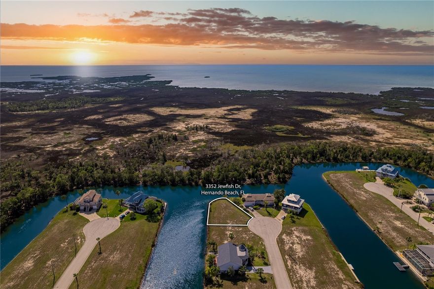 AMAZING SUNSET & GULF VIEWS when you Build on this Lot with 166 ft of Water Frontage! Come build your new Home where the Sandhill Cranes Roam and the Coastal Breezes Sway the Palm Trees. OWNER FINANCING OFFERED - Contact the Agent for More Information. It's just under a Quarter of an Acre and is located on the Cul-de-Sac for Expansive Views of the Gulf. This Beautiful Lot is in the AE flood zone for Better Flood Insurance Rates. Located in Hernando Beach South which is a Deed Restricted Community of Beautiful Homes with a low HOA fee of $330/year. This fee includes lawn care until you break ground on your new Custom Waterfront Home (Then the HOA Fee goes down to $306/year). For your convenience, there's a community boat slip and a community boat lift to get you out to the Salt Side & the Gulf for a day of Boating or Fishing. Hernando Beach is a Quaint Coastal Community that has Restaurants, Parks, Gift Shops & The Weeki Wachee Lake Preserve just East of Shoal Line Blvd. Down the Road are Fishing Villages, the Famous Weeki Wachee River & Pine Island. Soil test and Survey Available. Utilities are at the Street.