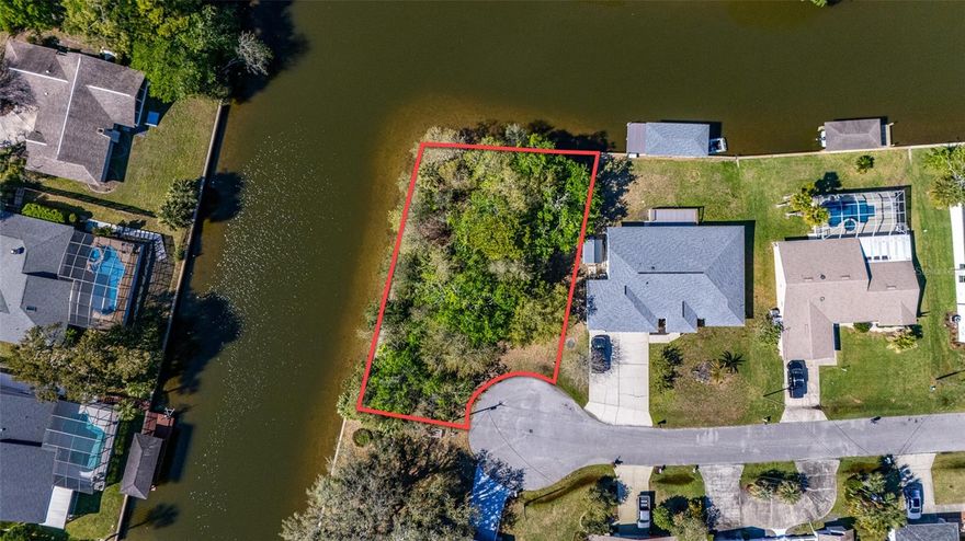 Prime Tip Lot on Saltwater Canal – Build Your Dream Waterfront Retreat! Exceptional opportunity to own a saltwater canal tip lot perfectly positioned at the end of a quiet cul-de-sac. It has over 13,000 sq. ft. AND approximately 239 feet on the water (based on Public Records).  With water on two sides of the lot this property offers expanded water views and added privacy—ideal for creating your ultimate Florida lifestyle. Bring your boat, fishing pole, and enjoy feeding the fish right from your backyard. With an easy route to the Intracoastal Waterway, this location is perfect for boating enthusiasts and those who love life on the water. Build with confidence and flexibility: No HOA, No time restrictions to build, and choose your own builder. Design the home you’ve always envisioned—complete with a pool, outdoor living space, and even a private dock. The possibilities are endless on this oversized, uniquely positioned lot. Conveniently located a short drive to beaches, golf courses, dining, shopping, and everyday essentials, this property truly captures the essence of Florida living. Don’t miss your chance to secure this one-of-a-kind waterfront lot—contact me today to get started!