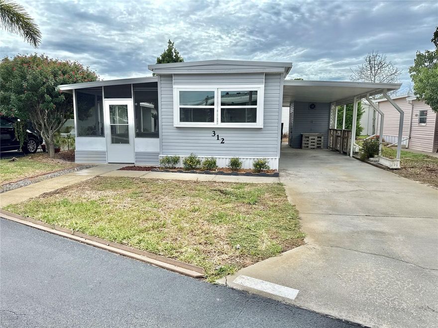 One or more photo(s) has been virtually staged. Looking to downsize or want an investment opportunity? This 2 bed/1 bath home with almost 700 sq ft of living space plus a 160 sq ft screened porch to enjoy the outdoors has been recently remodeled and offers features normally found in more expensive homes. INTERIOR UPGRADES IN 2025: Professional drywall with insulation and painted in neutral colors; beautiful luxury vinyl wide-plank flooring throughout for easy cleaning and walking; new double paned windows in home and new screens in lanai; new vapor barrier to protect the subflooring; beautiful new kitchen with stainless appliances, quartz countertops and custom cabinets; open floor plan with living/dining/kitchen in large space to place furniture in a number of configurations; new bath with easy clean one-piece shower, new toilet and sink & cabinet. New washer/dryer combo is inside for ease of use. Large primary bedroom with wall of closets and smaller second bedroom for hobbies, office or guest bedroom. Newer energy-efficient mini splits keep the home cool in summer/heated in winter. OUTSIDE FEATURES: Roofover has been inspected and is in good condition. Large shed for extra storage. Long carport holds two vehicles easily. Mature landscaping includes new plants. Home is steps from community park with private boat ramp and kayak launch for residents. Two dogs or cats up to 35 pounds are welcomed; two pets total each household. Renting is allowed with 2-month minimum. Management requires 675+ credit score. Proof of funds with contract. Exceptional value can be found here!