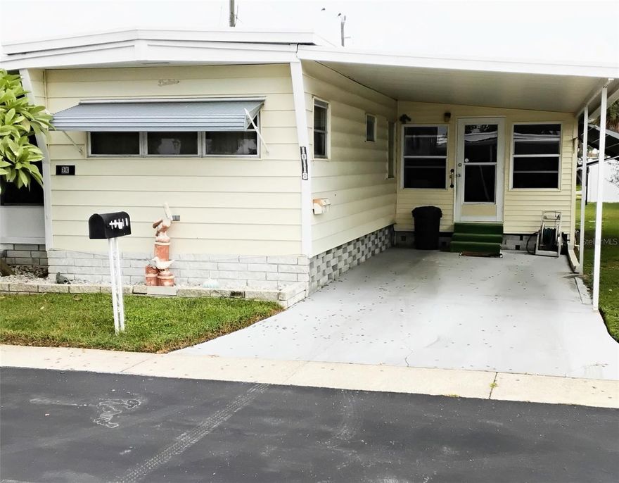 This home is located in Holiday Shores on beautiful Lake Seminole. You own the land!  A $65,000.00 Share is inluded. Low lot rent of $190.00.
 The home features a large living room, and a sunroom. Coastal paint colors and 2 inch faux wood blinds complete the Florida feel!  Plus an added bonus of 2 carports, (think boat or golf cart)
Water, Sewer, Twice weekly trash removal, Common grounds maintenance, reserves, boat ramp, pool and clubhouse are included
City is replacing sewer pipes in this community, so some roads are being dug up to allow for the new pipes.
