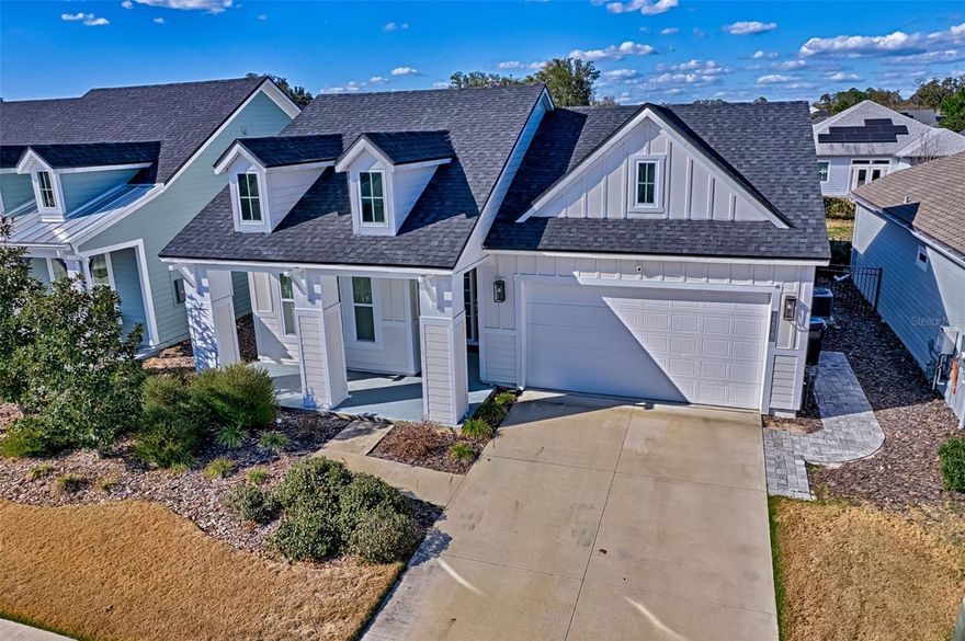 Welcome to Oakmont, the premier resort-style community in Gainesville! This gorgeous home is a 2022 Charlotte model with 3-bedrooms, 2-bathrooms, an additional office, and generously sized at 2,100 square feet. Choosing this option gives you a home with a fresh, modern look situated on a calm, well-established street, and a 2-minute bike ride to the amenity center. The design selections made in this home are modern, timeless, and very appealing. The layout is ideal, with a sizeable great room featuring gorgeous ceiling detail, a chef's kitchen, as well as a dining area with a view of backyard. The open design of the kitchen is perfect for entertaining with views of the entire living area and seating at the large island. The owner's suite has a very spacious bedroom, with a high ceiling, a walk-in closet, double vanity, and a large walk-in shower. The other side of this split-plan home has two full bedrooms and a full bathroom with a tub. In addition to the three bedrooms there is an office with a sliding barn door for privacy. Sliding glass doors leading to a spacious porch make the living area more adaptable and versatile. Adjacent to the garage is a laundry room with a utility sink. The seller selected the following upgrades when building this home: quartz countertops in the kitchen and bathrooms, an upgraded gas cook top with hood, gas connections for a summer kitchen, and interior shutters for privacy. Oakmont features resort-style living with a large amenity center with a beach entry pool, splash area for little ones, lap swimming lanes, a gym, event space, trails, playground, tennis, pickle ball, basketball, and volleyball. This community is also on CLAY ELECTRIC! Oakmont is in SW Gainesville making it convenient to Hawkstone Country Club, Tioga Town Center, UF, Santa Fe College, UF Health, HCA North FL Hospital, and loads of retail at Butler Plaza and Celebration Pointe.