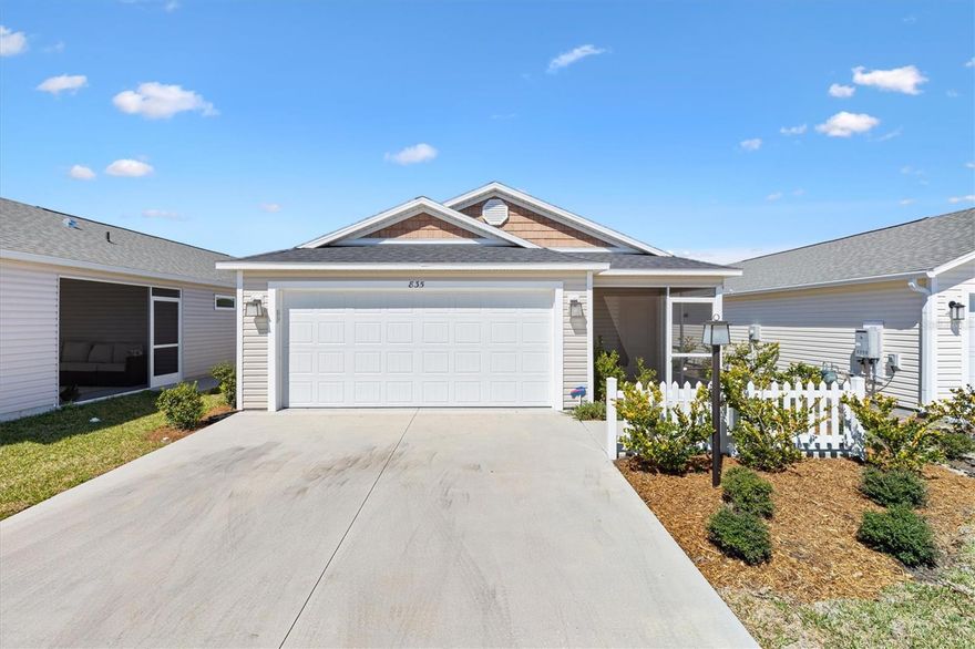 Welcome to this two bedroom two bathroom Topaz patio villa with TWO car garage and rear privacy. As you approach this home take note of the landscape with a decorative white fence. This nearly new home features a front screened lanai where you can enjoy morning coffee or visiting with friends or a side patio for enjoying the outdoor or grilling.  As you enter this home take note of the open floor plan with vinyl flooring and volume ceilings. The kitchen area boasts of white cabinetry with stainless appliances, island with sink, pantry, and desk area. This home also features interior laundry. The primary suite features ensuite bath with double sinks and walk-in closet. In addition is a second bedroom for guests or possible office area. The village of Dabney is located in the southern end of the villages in close proximity to Sawgrass Grove, the Dabney recreation center, walking trails and golf.