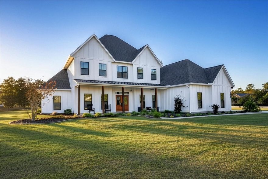 Set on over five picturesque acres in the sought-after Cinnamon Hills neighborhood of High Springs, this stunning 5 bedroom, 3.5 bath modern farmhouse blends timeless charm with thoughtful, high end design. Beautiful landscaping, a side entry garage, wood column accents, and a striking wood front door create exceptional curb appeal, while the large front porch invites you to slow down and enjoy peaceful mornings or evenings in rocking chairs. Step inside to an airy, light filled entryway that immediately feels welcoming. Just off the entry, a private office provides the ideal work from home space. The heart of the home is the living room with a cozy mantle and expansive windows, seamlessly opening to a chef’s dream kitchen featuring ample workspace and a swinging door pantry room that is both functional and charming. A thoughtfully designed walkway off the kitchen includes a dry bar that opens to the dining room, perfect for entertaining and hosting gatherings. The spacious laundry room is conveniently located off the kitchen, along with a half bath that offers direct access to the backyard, ideal for indoor-outdoor living. The garage entry leads into a dedicated mudroom, making everyday comings and goings effortless and organized. The primary suite is located on the main floor, offering a private retreat with its own sitting area, two walk-in closets, and a spa-like bathroom complete with a soaking tub, walk-in shower, and double vanity. Dual stair access, from both the entryway and the main living space, leads upstairs to four additional bedrooms and two full bathrooms, providing flexibility for guests, family, or multi-purpose use. A shared common area upstairs creates the perfect reading nook or quiet lounge space. Out back, relax on the covered rear porch overlooking the expansive backyard and imagine the endless possibilities...a future pool, garden, outdoor entertaining spaces, or simply enjoying the peace and privacy that acreage living provides. All with a 2.5 car garage offering plenty of space! This exceptional property offers space, style, and serenity, all just minutes from the charm of High Springs. This location in convenient to I-75, Gainesville, Alachua, and Lake City!