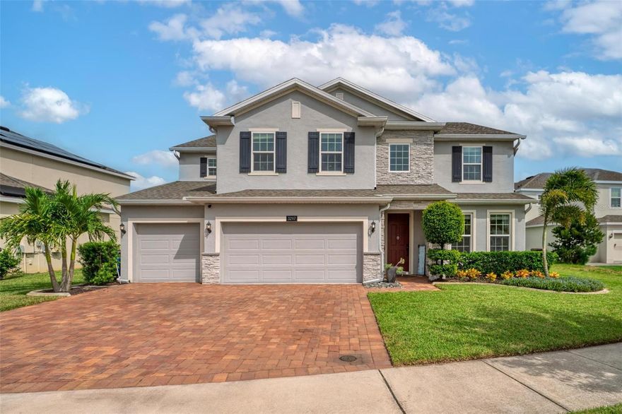 This extraordinary 3,800 sq. ft. Exbury plan offers a luxurious waterfront lifestyle on a beautiful homesite at Hanover Lakes, featuring an open-concept design with 5 Bedrooms, 3.5 Baths, and a 3-car garage, highlighted by an incredible 1st Floor Primary Suite. The property provides direct water access via a navigable canal to the Alligator Chain of Lakes for great fishing and boating opportunities across 5 lakes. The oversized kitchen is a chef's delight with beautiful 42" cabinets, quartz countertops, a tile backsplash, expansive island, walk-in pantry, Stainless appliances, and an adjacent Butler's Pantry leading to the Dining Room. A dramatic 2-story Family Room overlooks a spacious covered rear Lanai for entertaining, and the home features upgraded luxury vinyl flooring in main 1st-floor living areas and included window blinds throughout. The Primary Bedroom's luxurious en-suite bath boasts 2 walk-in closets, separate quartz vanities, a free-standing soaking tub, and a separate walk-in shower. Additional gathering space is found in the 2nd-floor Loft/Family Room, ideal for media or exercise. The exterior includes an attractive brick paver driveway and a private, completely screened, salt water pool with a splash pad and beautiful waterfall. Exceptional community amenities include a resort-style pool, splash pad, and playground, and the convenient location is close to Disney, Universal, Sea World, nearby Atlantic Beaches, and expressways for easy access to Downtown Orlando.