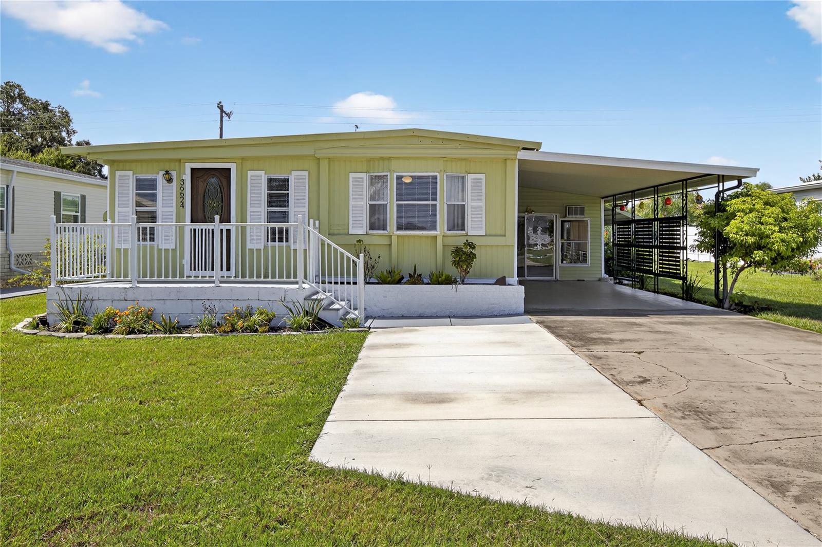 Wonderful and well-maintained mobile home with 3 bedrooms/1.5 bathrooms, a carport, Florida room and large storage shed in the back! Located in Betmar Acres- a quiet 55+ golf community with a LOW HOA fee of $435/ YEAR- you own the land! No lot rent. Inside you'll find an open layout with a spacious living room, an open kitchen and dining area, a HUGE Florida room- perfect for lounging or entertaining- just off the side of the kitchen cooled by a wall ac unit. Large laundry room behind the Florida room- also accessible from the hallway. Community has a multitude of amenities including 2 swimming pools and hot tubs, 3 clubhouses, a library, many walking paths, game rooms and enclosed shuffleboard courts, with 27 holes of golf! Conveniences such as shopping, restaurants, medical facilities, theater, bowling, YMCA, and more- all only minutes away. Water heater replaced in 2023, AC from 2020, Metal roof has no leaks. With some upgrades and personal touches- this can be your perfect retirement home in sunny Zephyrhills, Florida!
